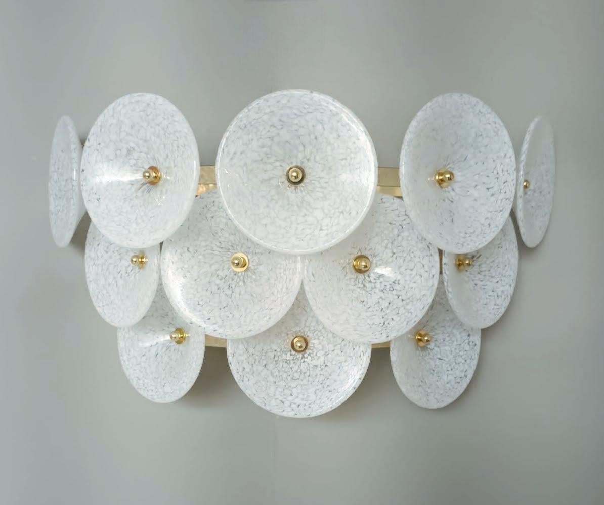 Italian wall lights with white Murano glass trumpets mounted on gold metal frames / Made in Italy in the style of Vistosi, 1970s
2 lights / E12 or E14 type / max 40W each
Measures: Height 10 inches, width 20.5 inches, depth 7.5 inches
3 available in