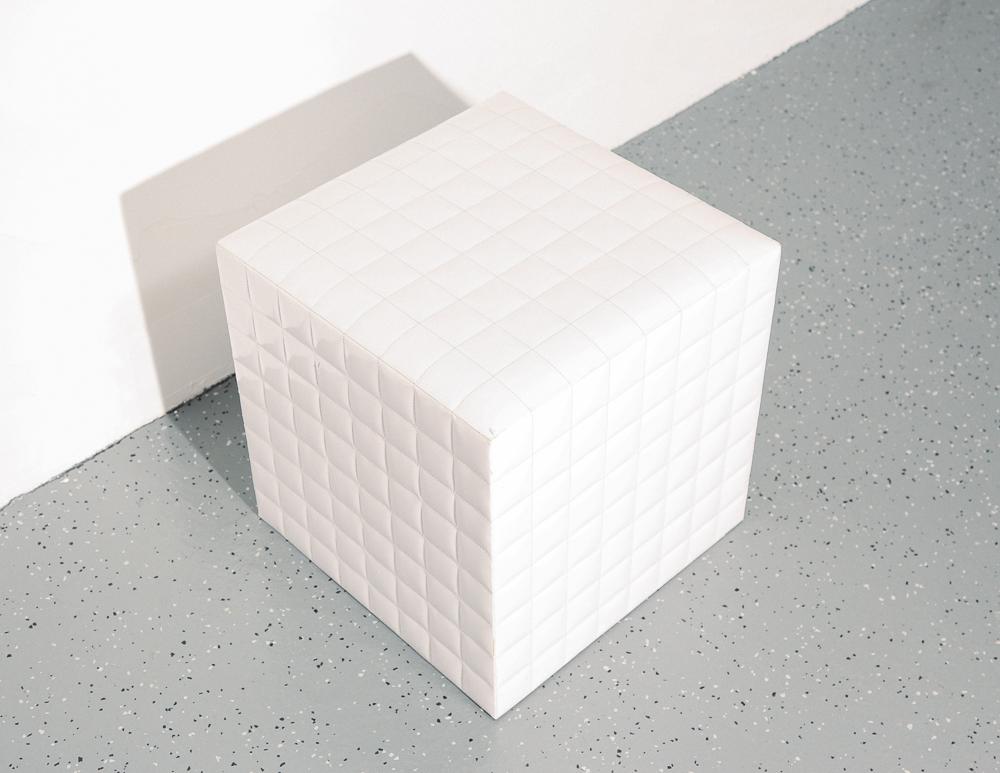 Crisp white vinyl tufted square cube stool ottoman. Modernist stitched square grid design.