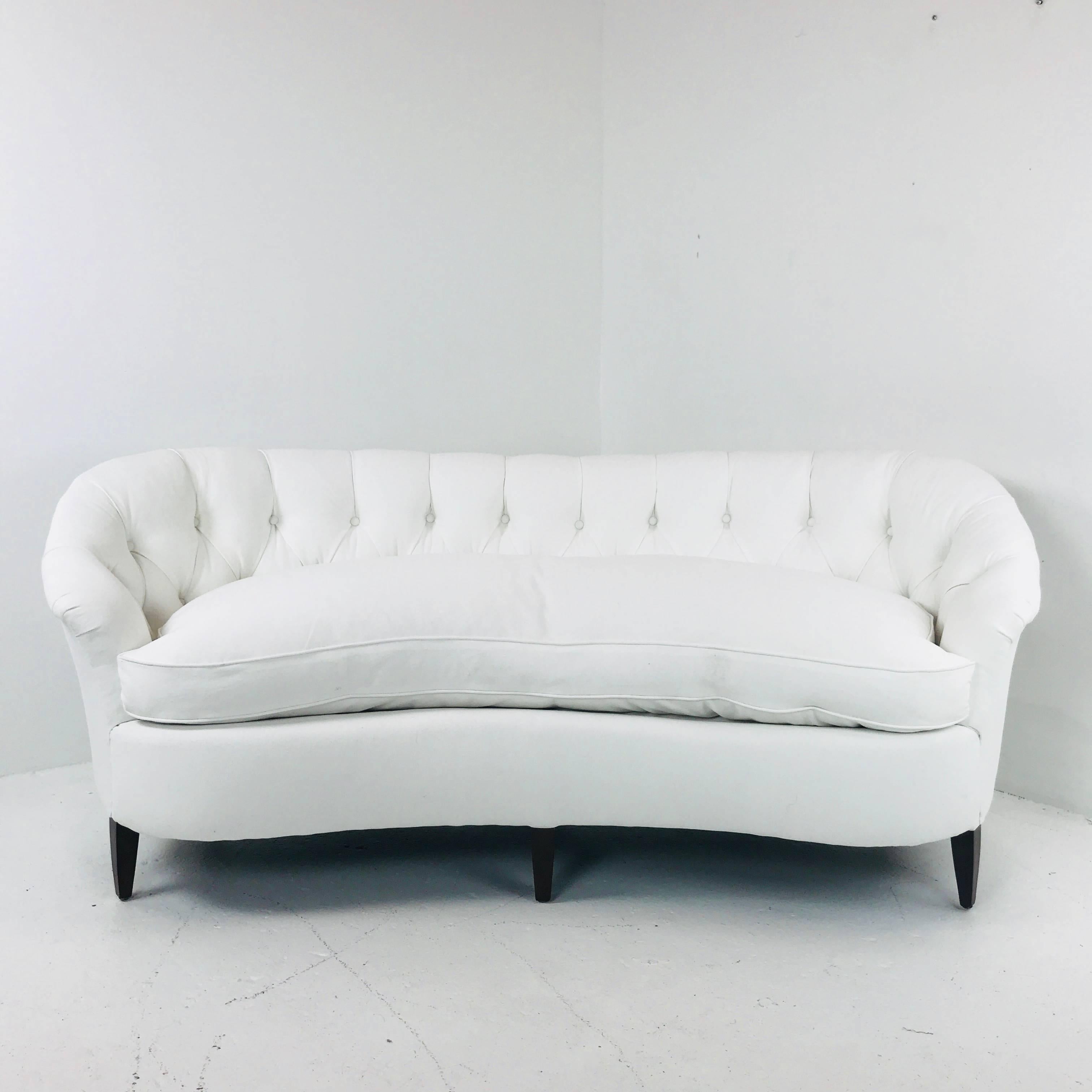 White tufted curved regency petite sofa. Sofa was recently upholstered in March 2018. Sofa is in excellent condition. 

Dimensions: 73