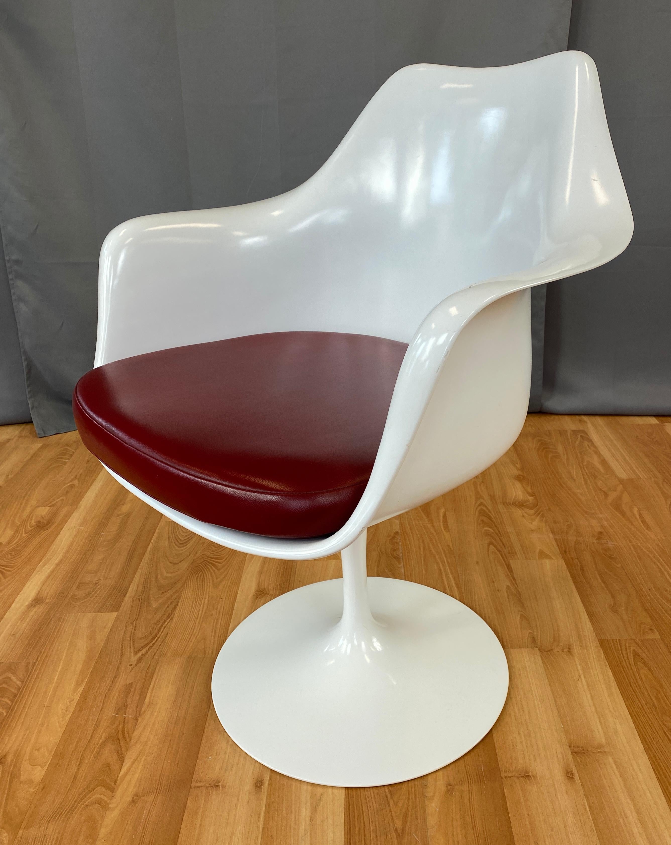 Offered here is a white tulip armchair designed by Eero Saarinen and made by Knoll.
All white chair, with Ox Blood leather upholstery, on Knoll's web site we think it's Yolo Leather Garnet.
 