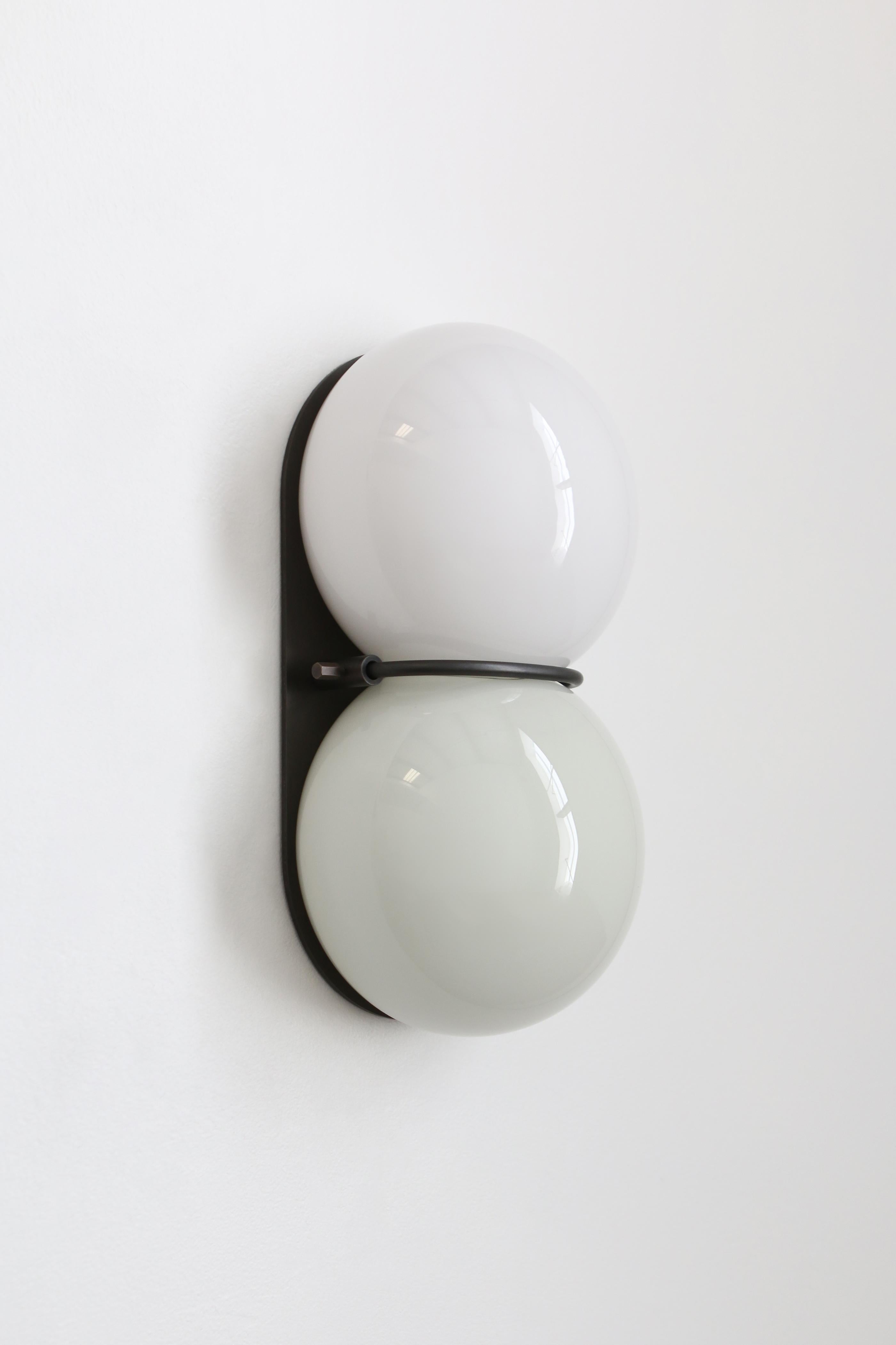 White twin 1.0 sconce by SkLO
Dimensions: D 10 x W 15 x H 28 cm
Materials: glass, metal
Available in blue, mint green, oyster, pastel pink and white palette.
Available in 4 metal finishes: dark oxidized, brushed brass, polished nickel, brushed