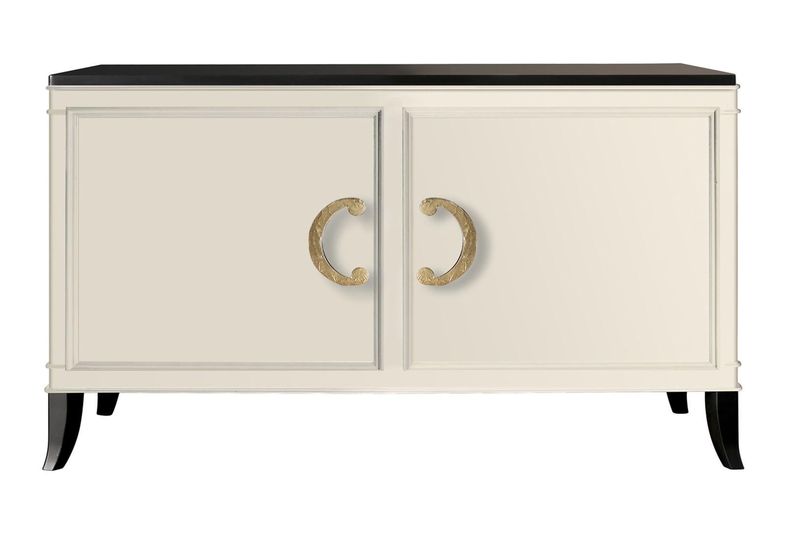 This sophisticated two-door sideboard was crafted entirely by the hands of expert Italian artisans in wood. Its wow metal handles feature a crinkled texture and are available in silver or gold leaf finishes. This piece was inspired by the Art Deco