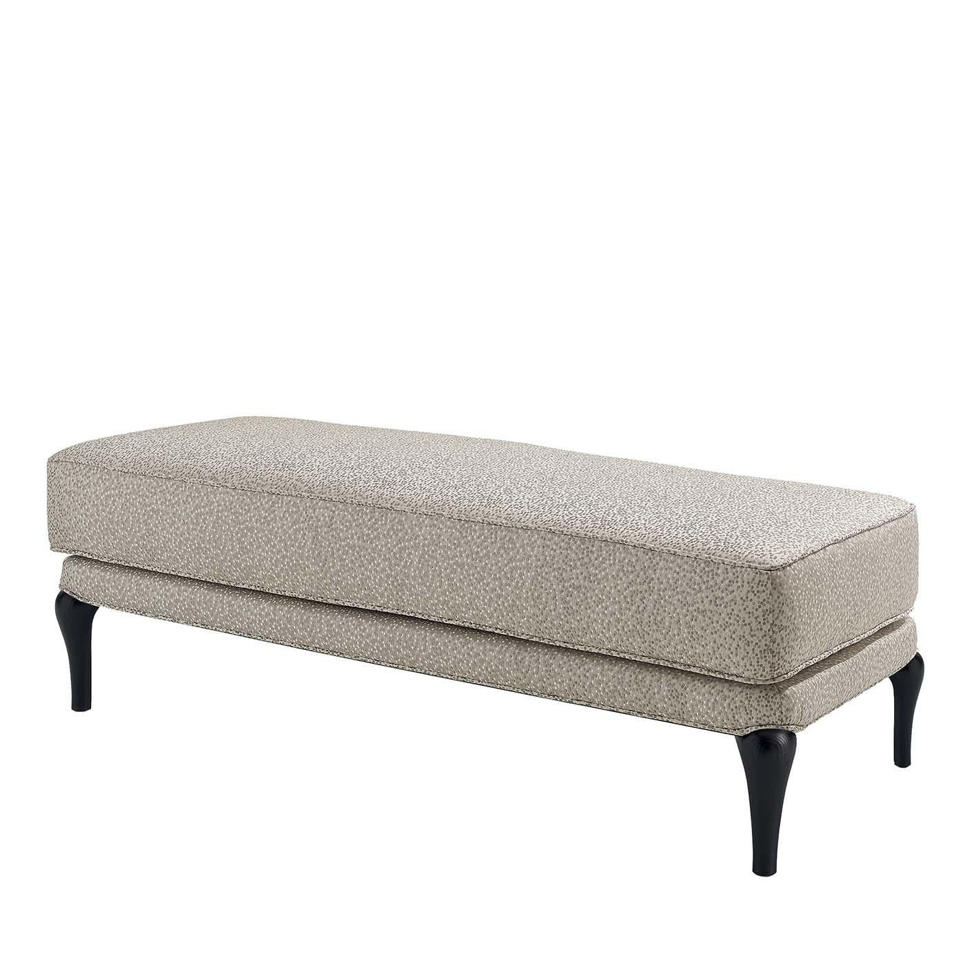 This elegant bench boasts a black-lacquered solid ash structure with short feet that supports a plain and rigorous silhouette upholstered of a cream-white melange fabric. A unique piece of delicate sophistication, this bench will find its perfect