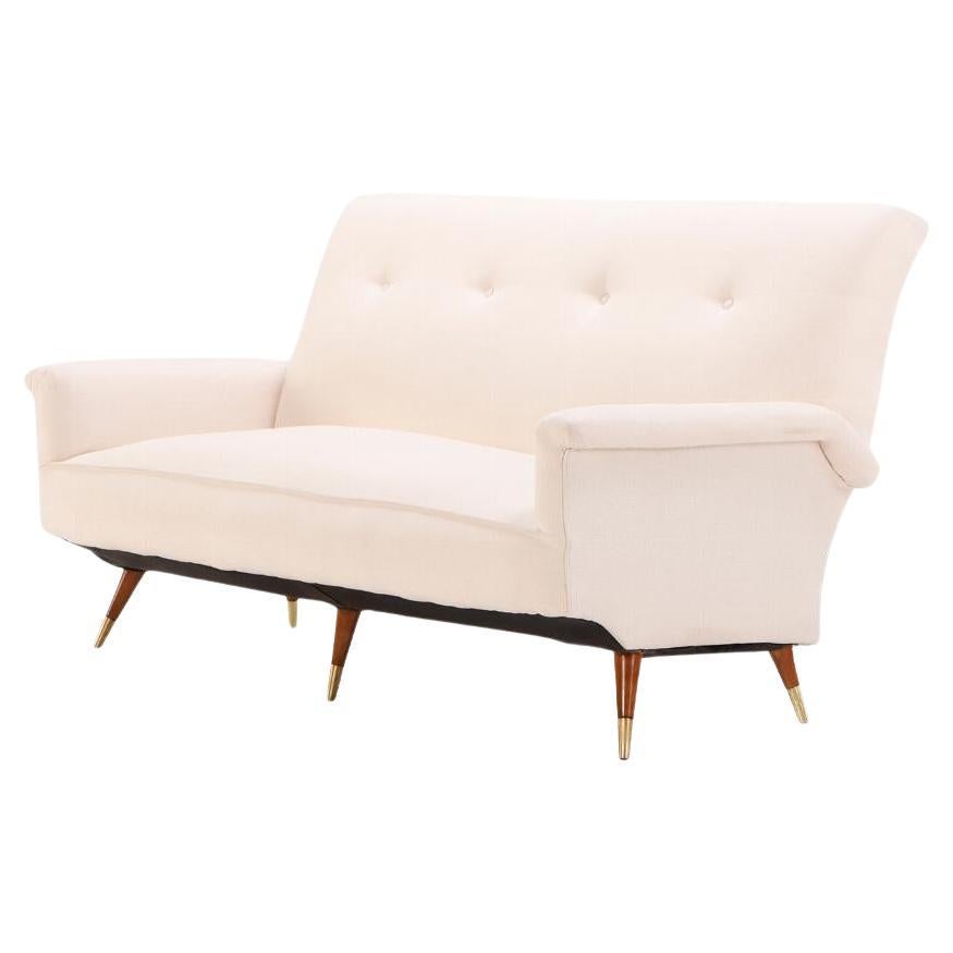 White upholstered Italian three leg sofa circa 1950, having new fabric. For Sale