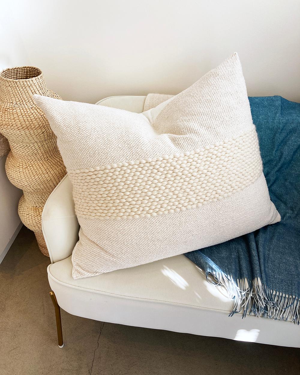 A very large fun throw pillow. This large and stylish floor pillow is skillfully crafted with a mix of organic cotton and wool with a striped weave texture. Perfect as a modern, rustic, and contemporary home decor accent, this floor pillow is great