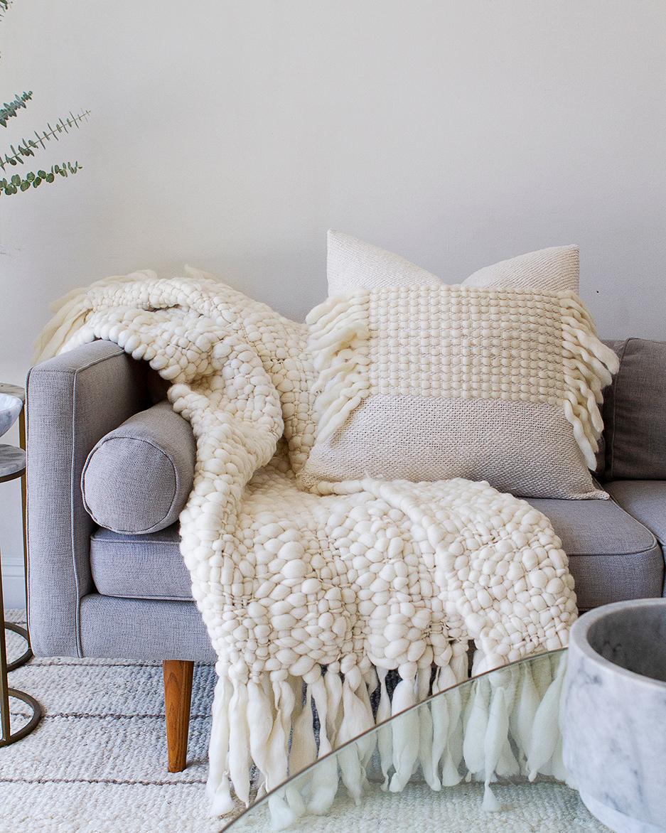 The Valle with Fringe Pillow is a statement piece perfect for modern, contemporary living. Crafted with a mix of natural cotton and wool, the white patterned texture is accented with full fringe for added texture. Soft and plush, this throw pillow