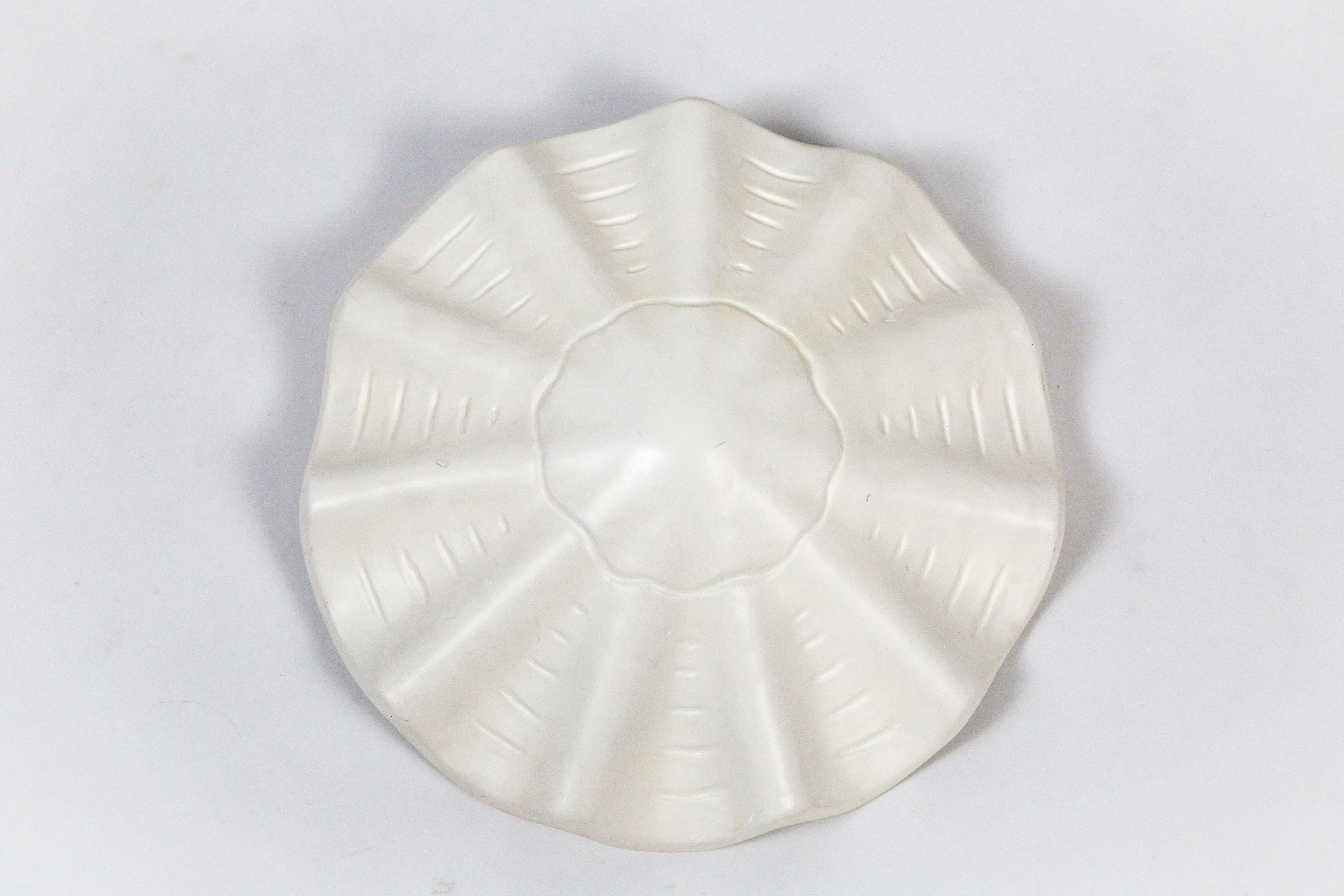 A white, lacquered plaster pendant in an undulating shell shape, with scalloped edges and imprinted lines accentuating the form. A newer take on Francis Elkins's 1940s plaster plafonnier, this later version was produced in the 1960s and 1970s by
