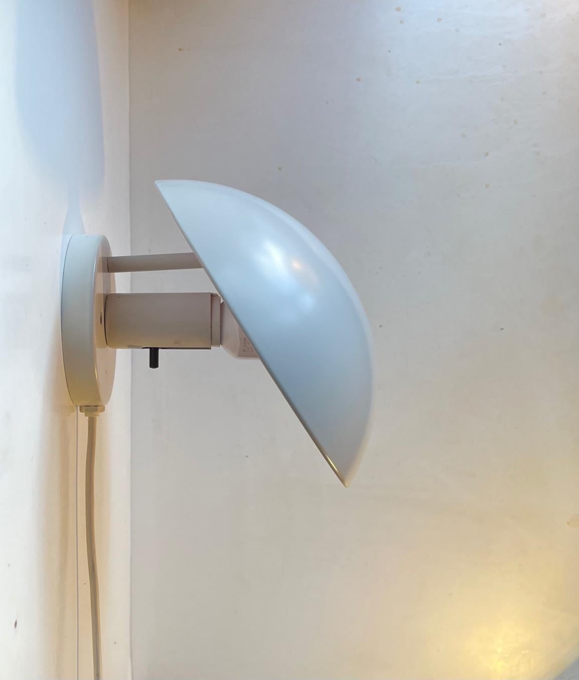 1st series white PH Hat wall lamp designed by Poul Henningsen in the late 1970s and manufactured by Louis Poulsen in Denmark. It features angle-adjustable shade, original pink lacquer and push-pin on/of switch to the socket. Its labeled with