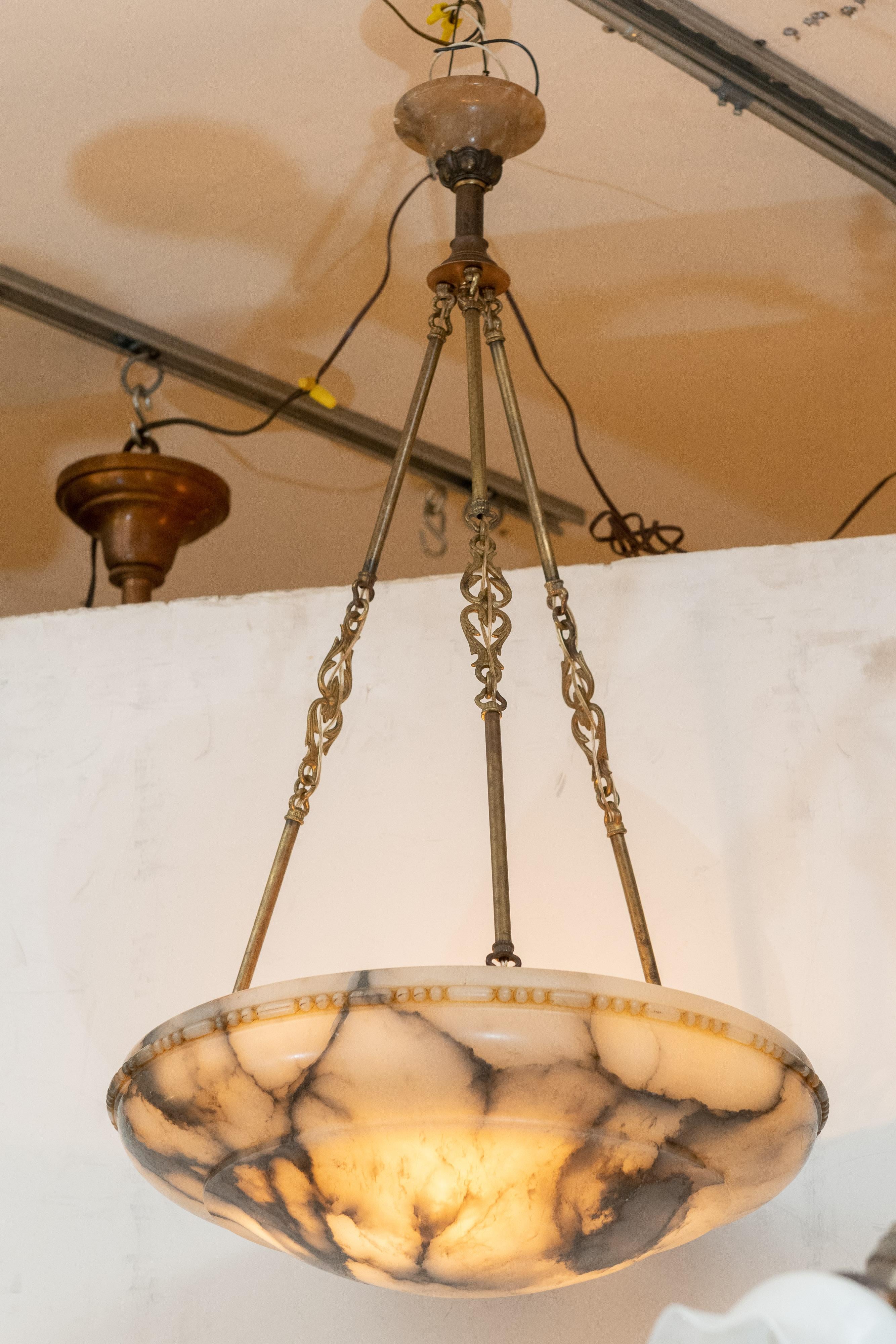 Whether you are doing Mid-Century Modern or antique lighting, this is a fabulous choice. Easily the best white alabaster chandelier we have ever offered. The white and black is eye catching, and then add on the original hardware to include the
