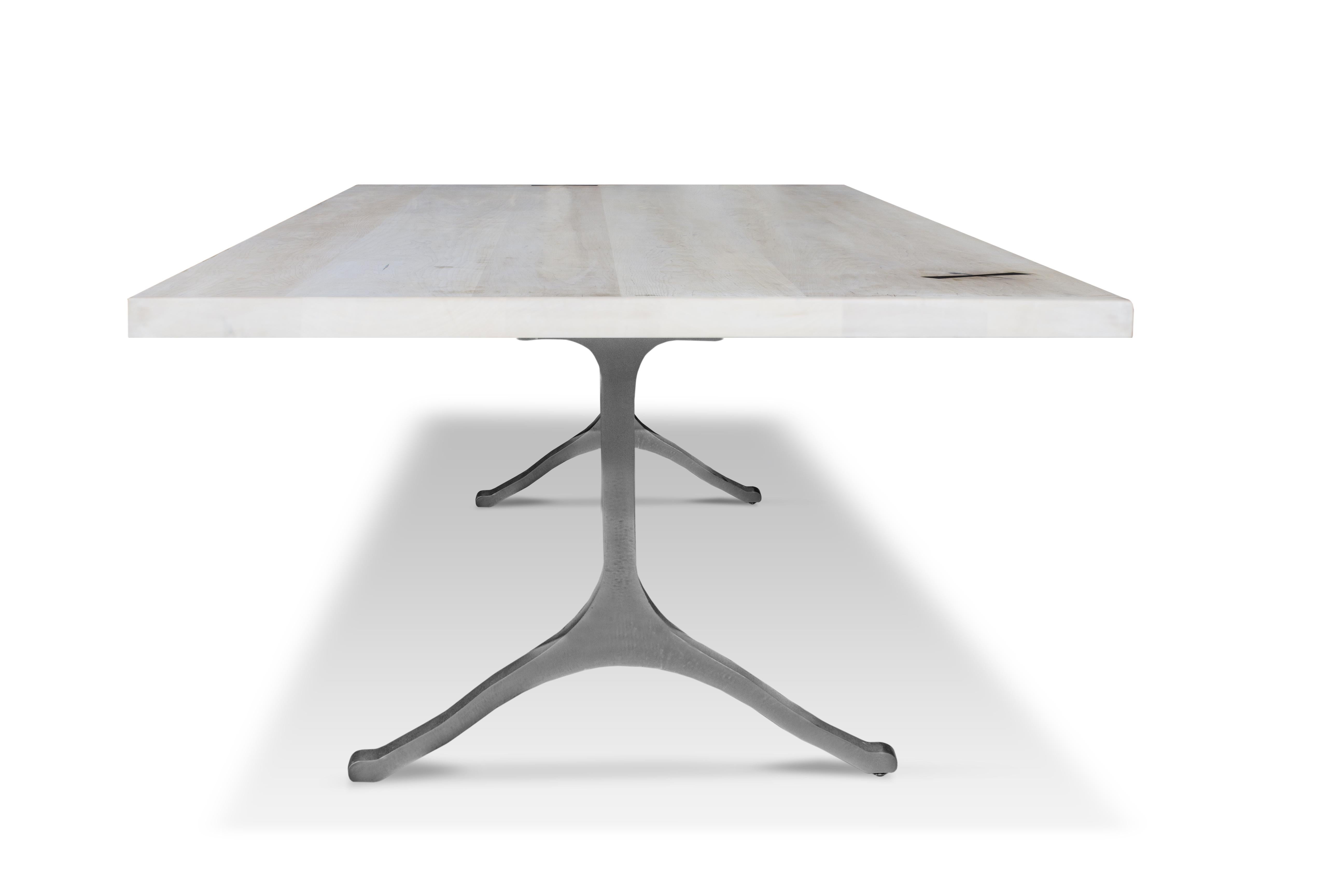 The Mark Jupiter Wishbone table is a center piece to his entire collection of dining and work tables. It's hard to go wrong with a great wishbone base combined with the perfect solid wood top. Shown here in a white washed maple with ebony inlay