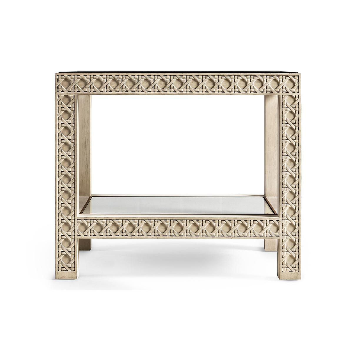 White washed oak end table, featuring a digitally carved, traditional woven cane design, the table boasts mesmerizing textural layers. White-washed oak with stunning grain detail is paired flawlessly with a polished glass top and linen, glass-topped