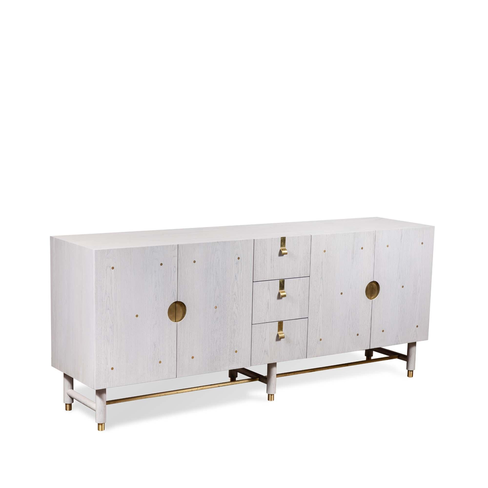 The Niguel cabinet by Lawson-Fenning has a brass stretcher on the base, brass inlaid details on the doors and insert brass handles. The interior is lacquered. 

The Lawson-Fenning Collection is designed and handmade in Los Angeles, California. Reach