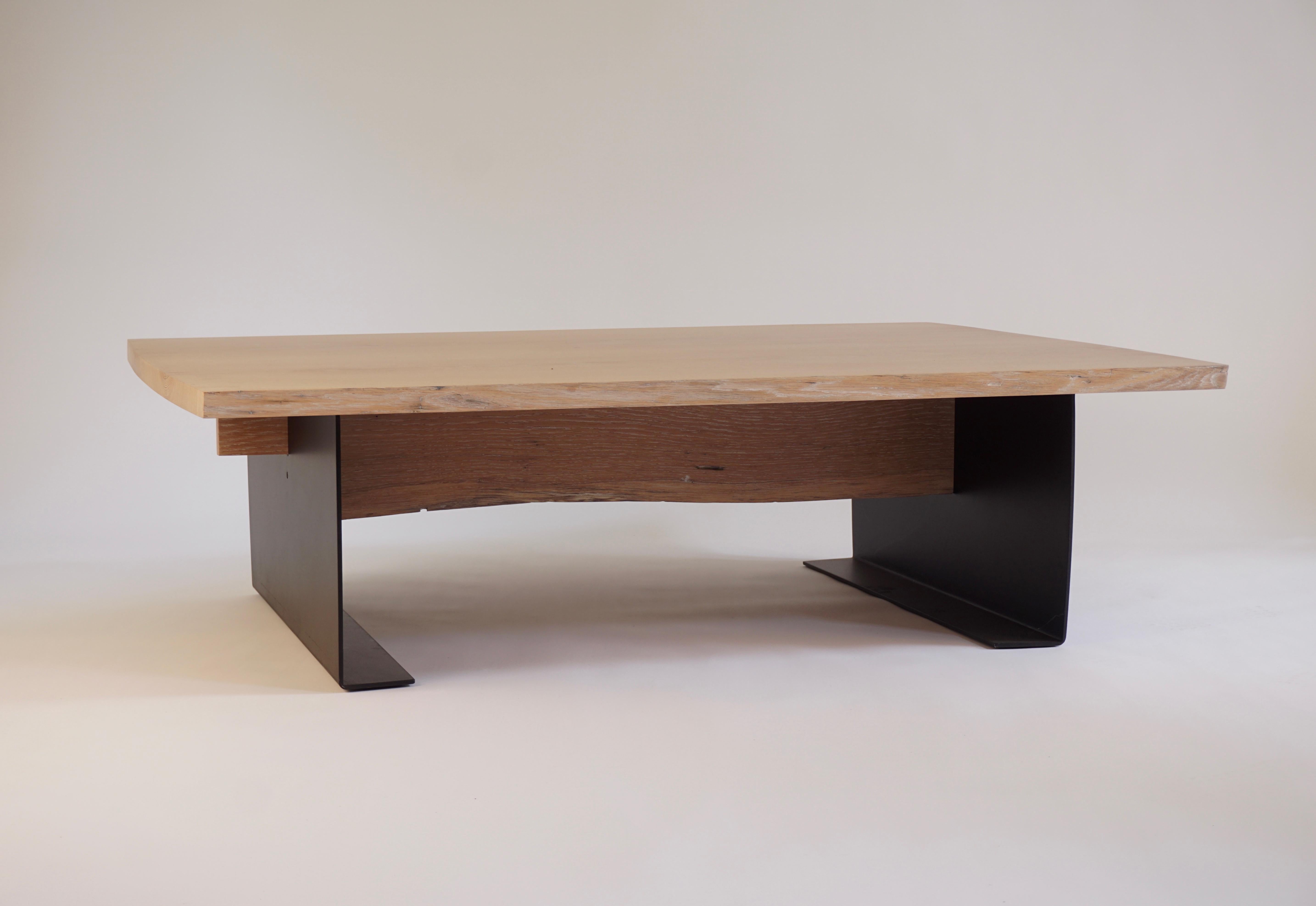 This trestle coffee table by Chris Lehrecke is made in white oak with a white washed finish. This version of the Trestle Coffee Table is from the 2005 Trestle Collection. The book matched white oak planks for this table were locally sourced from the