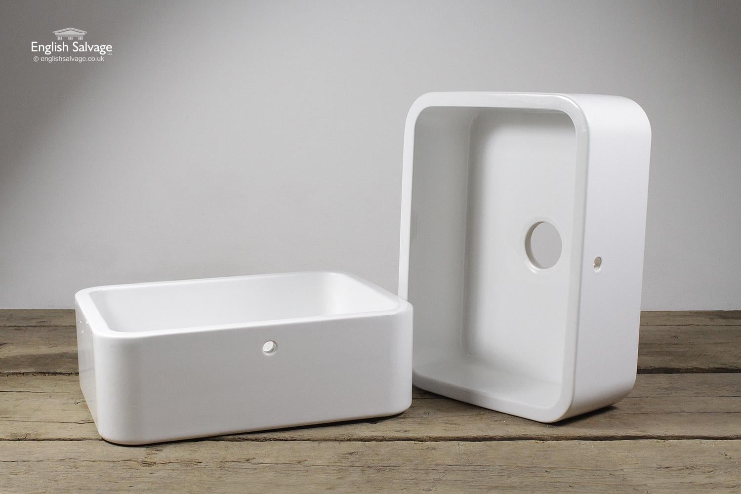 White enamel (Belfast style) sinks, with overflows, made in the UK by Whitebirk Sink Co. These are unused seconds. There are some small faults in the glaze finish as highlighted in the photos. The internal sink bowl is 53.5cm wide x 40cm deep, the