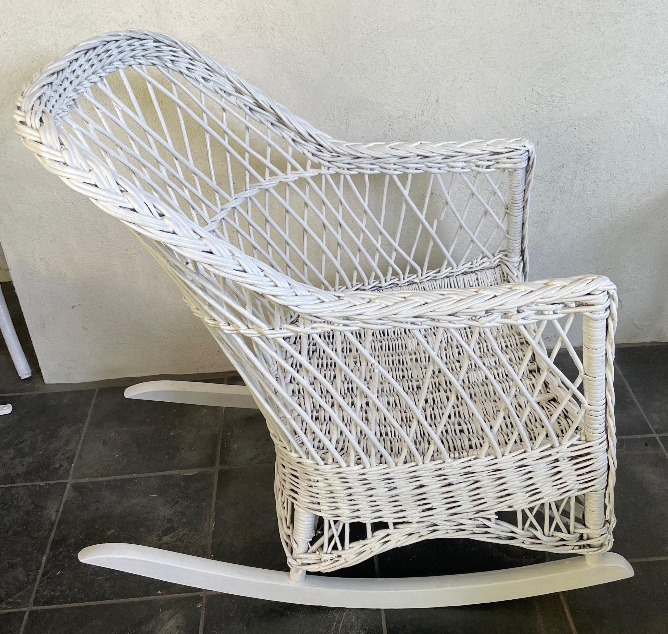 White wicker rocking chair. Vintage American sturdy white painted wicker rocker. See photos for vintage condition. United States, circa 1930's
Dimensions: 25” W x 36” D x 33” H; seat 19” wide x 19” deep x 17
