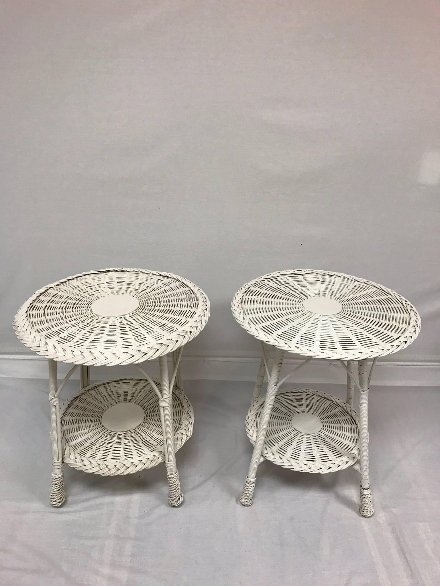 A set of vintage early 20th century white-painted wicker tables that would be perfection upon a porch or within a sun room. Stack piles of books or verdant ferns upon the top or low-to-base shelf for form marries function. Classic Americana! Please