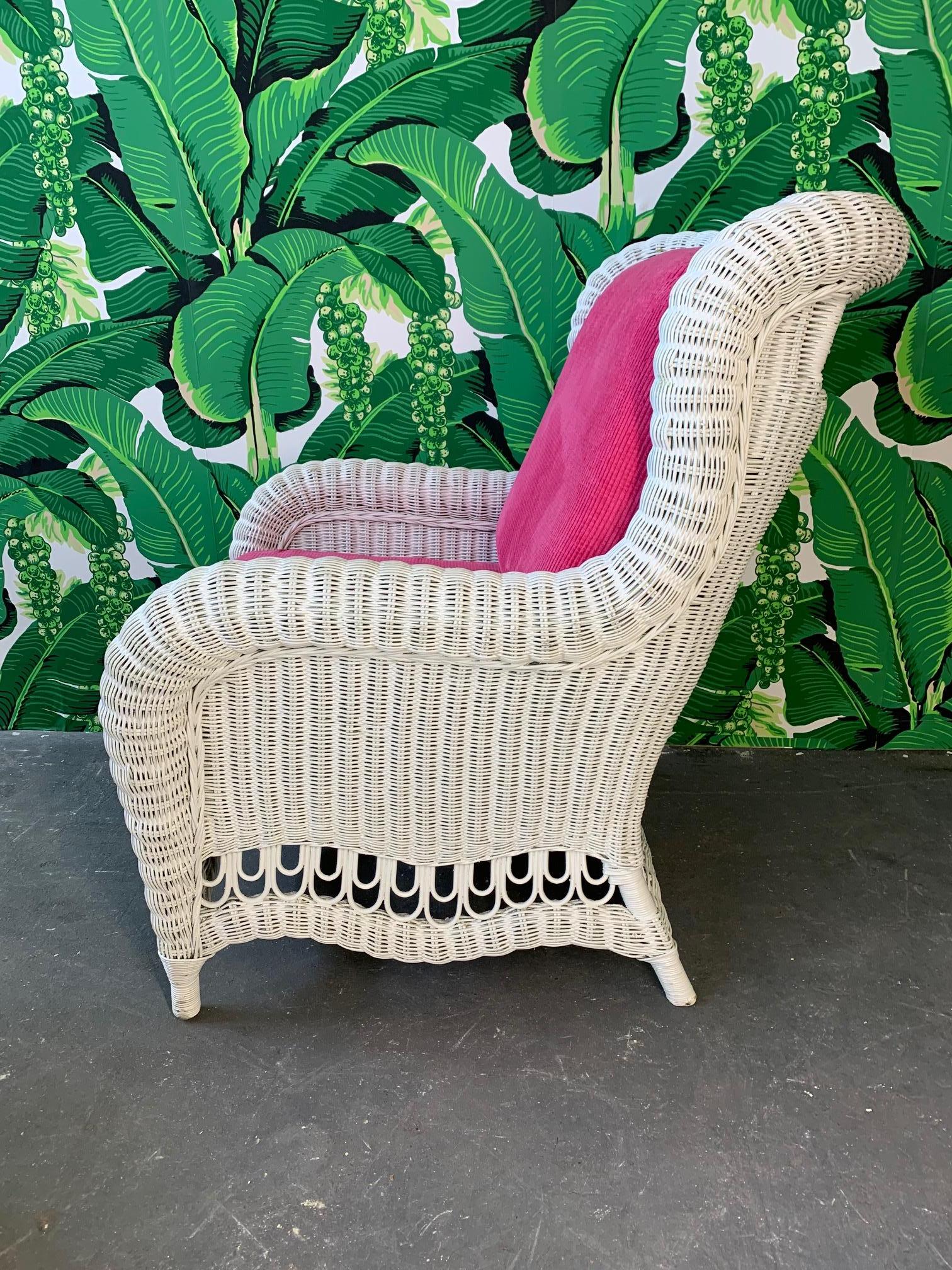 Vintage wicker wingback chair with matching ottoman features cheery pink chenille upholstery. Excellent vintage condition with minor imperfections to finish. Structurally sound.