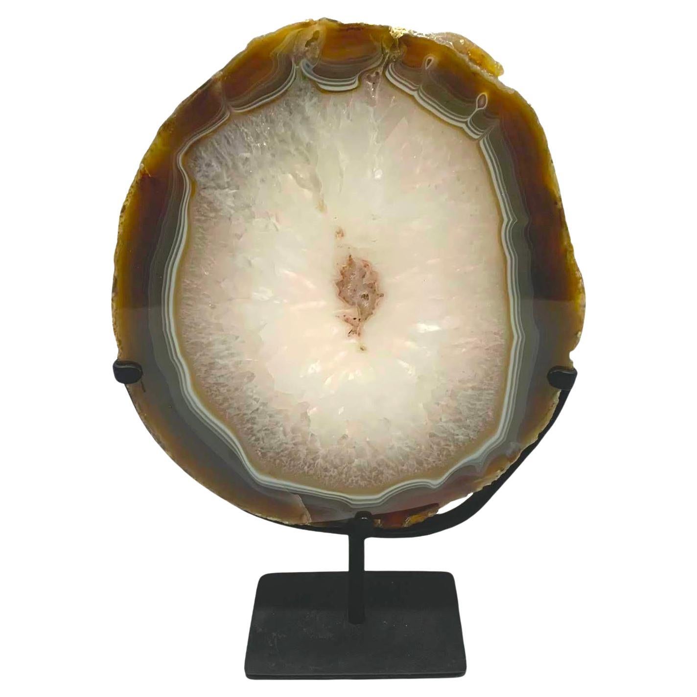 Prehistoric Brazilian thick agate geode on stand.
White center with brown border.
Metal stand measures 5