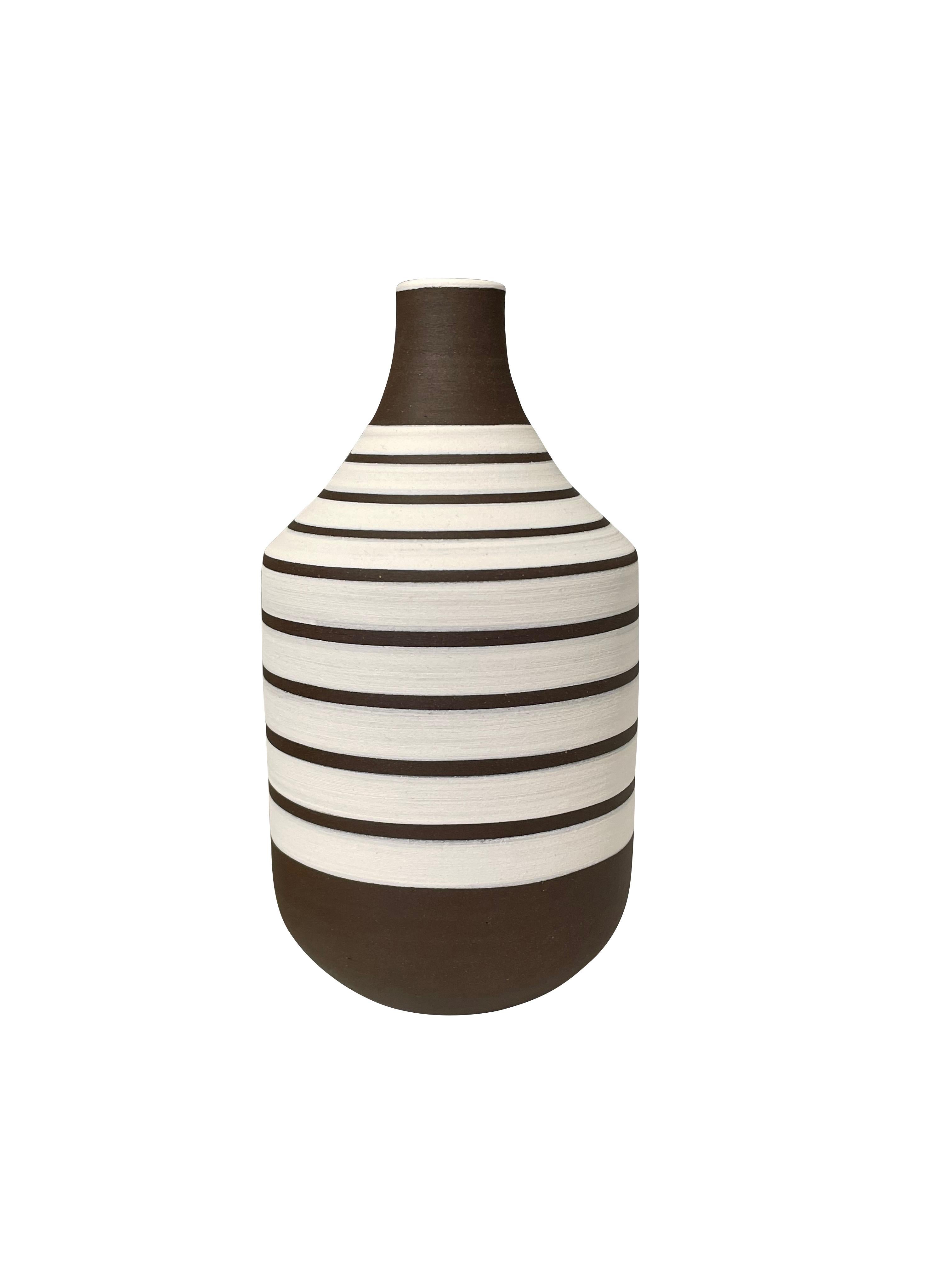 Contemporary Turkish white ground vase with dark brown stripes.
Dark brown wide mouth opening and base.
Can hold water.
From a large collection.