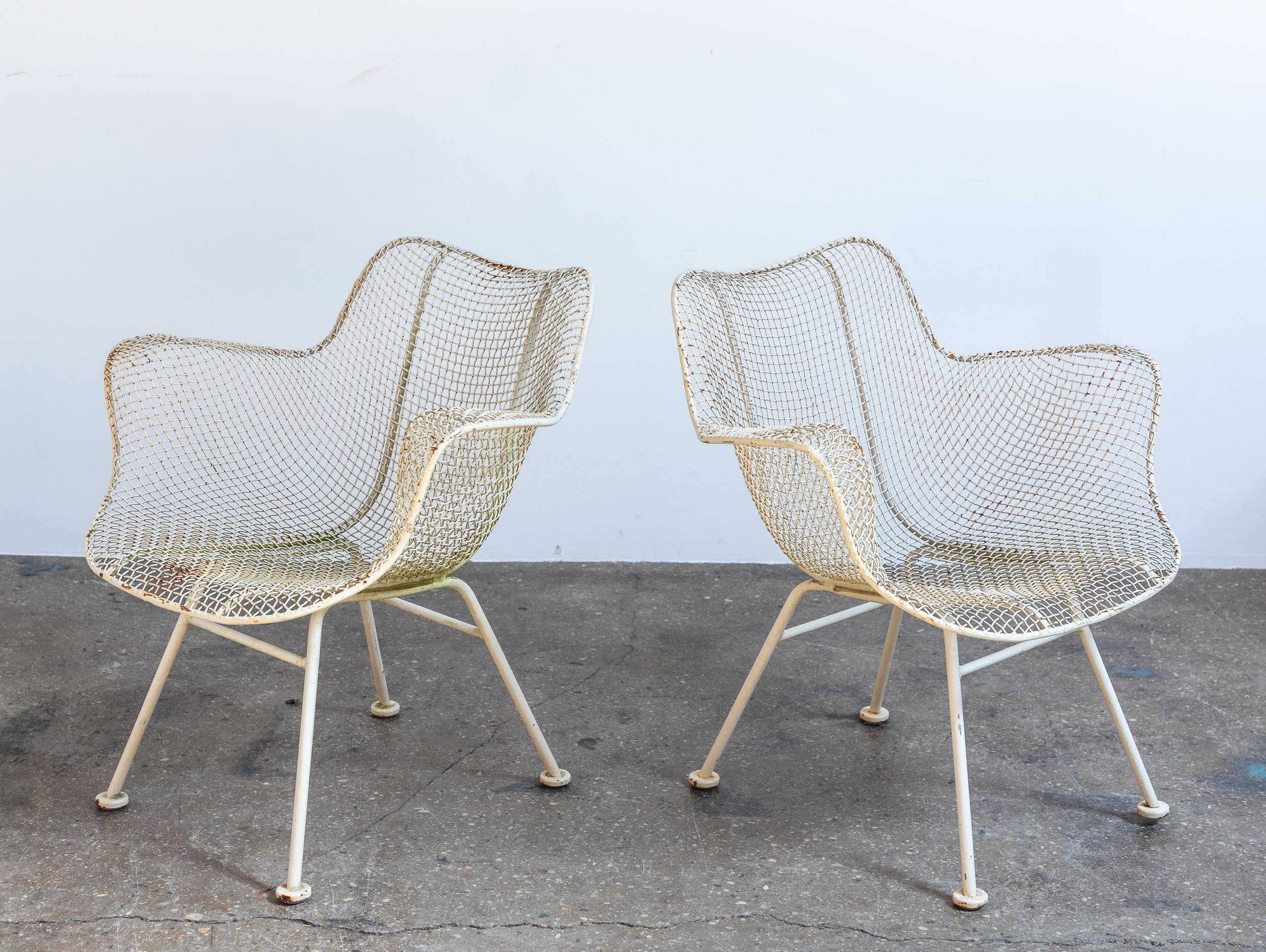 Nice set of four Sculptura armchairs for dining. A versatile option for outdoor entertaining, this set is dining chair height so can be used with a patio table. The wrought iron frames and woven mesh steel seats are strong and can stand all weather.