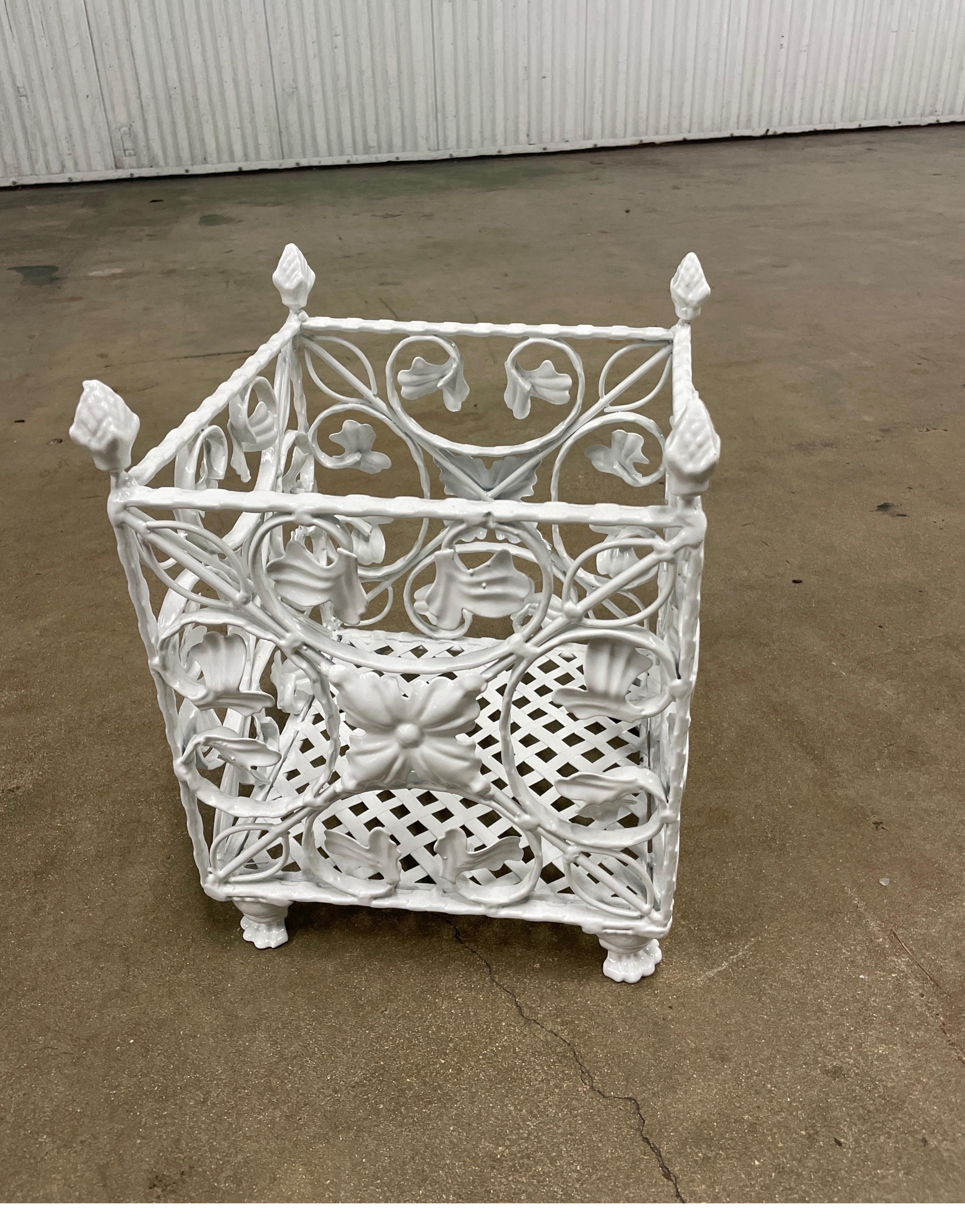 Vintage square footed wrought iron planter box with lattice bottom and scrolled sides with leaves. Each corner finished with an acorn on top.