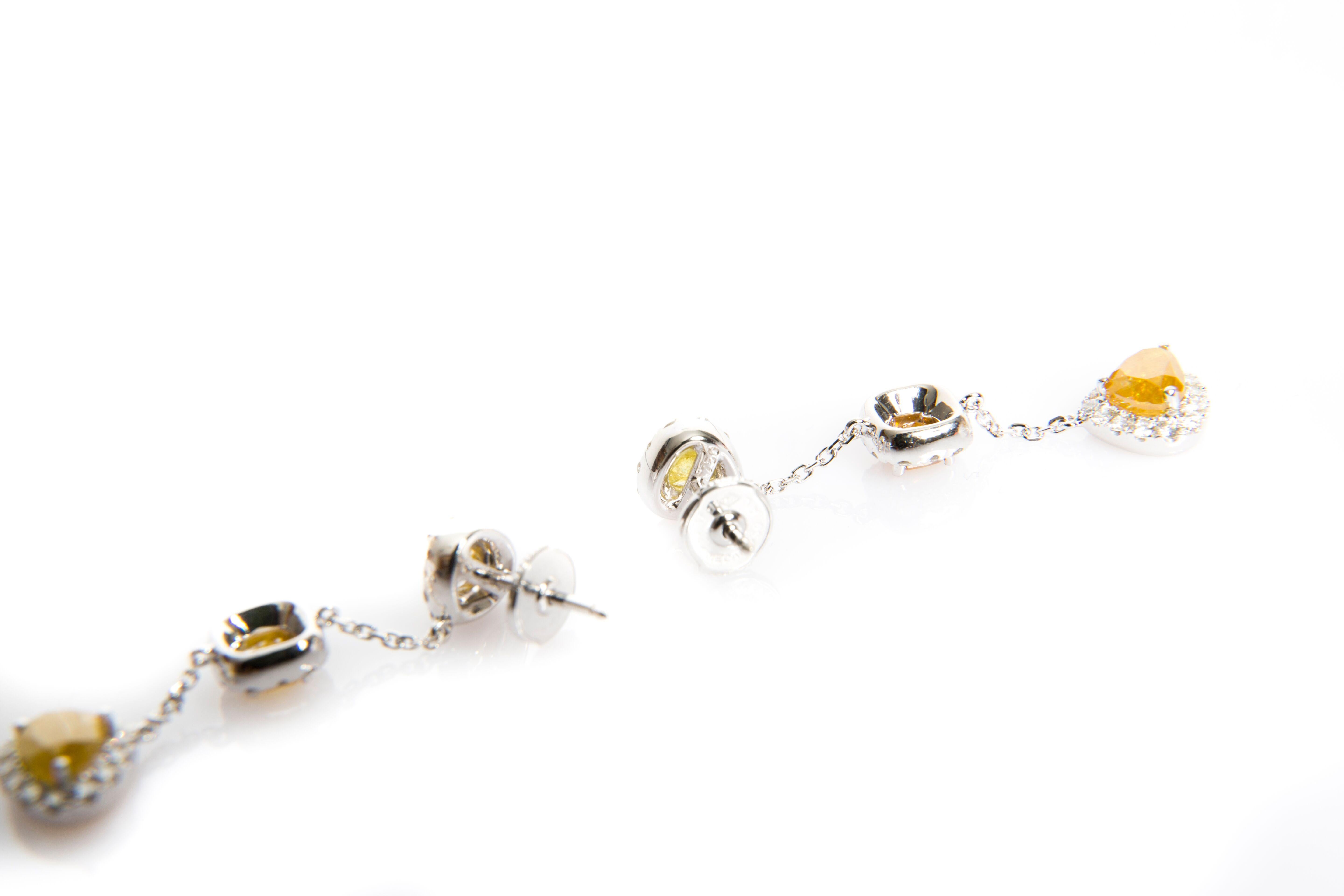 These handcrafted pair of earrings are lovingly handmade with yellow, brown and white diamonds (total 4.81 cts) mounted in 18K white gold.
Very elegant summery design for cocktail dresses or casual days outfits; these earrings will leave your