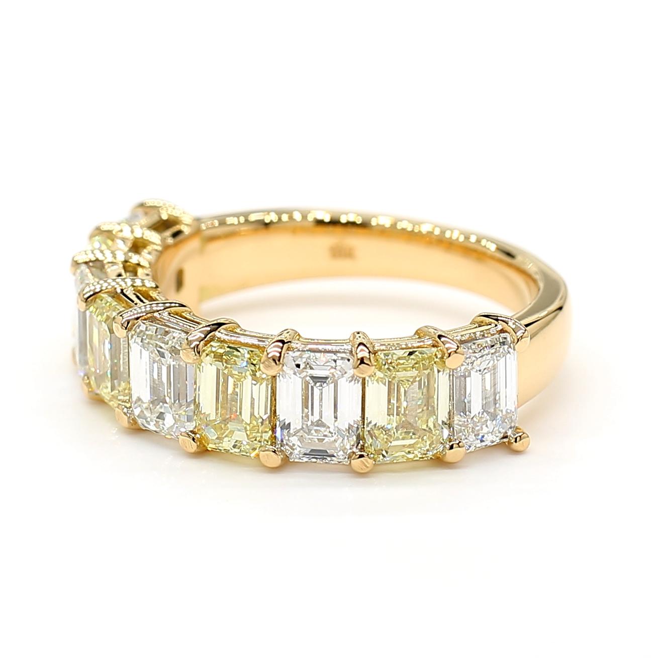This very impressive yellow & white diamond emerald cut alternating halfway eternity Diamond Ring is a testament to fine craftsmanship and timeless design. Perfect for those who appreciate the beauty of natural diamonds, this ring offers a balance