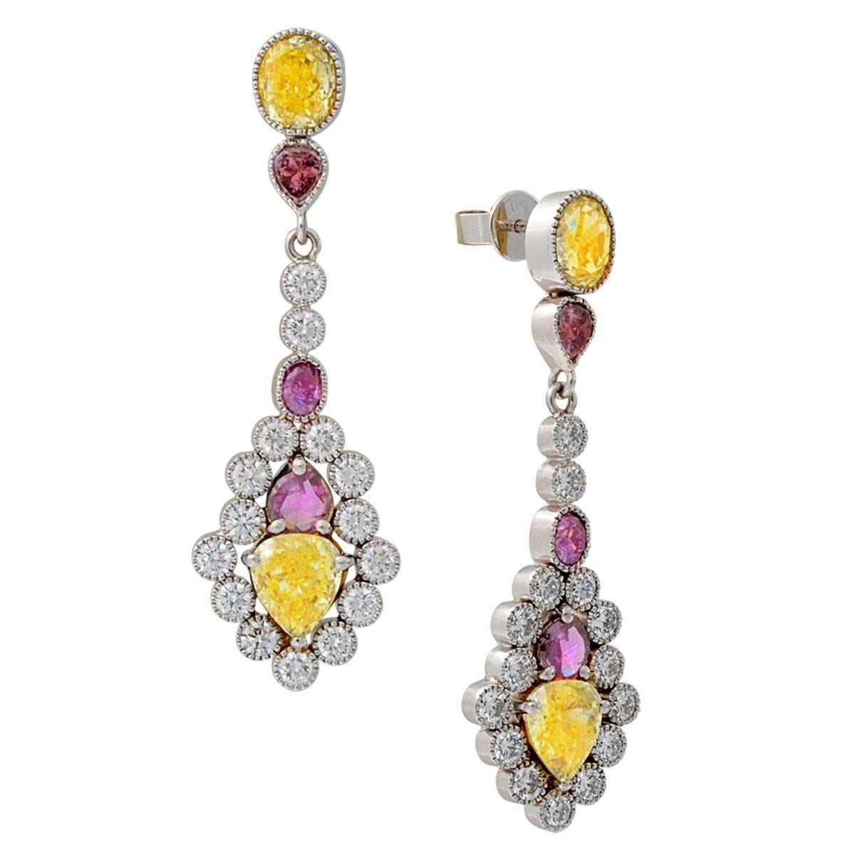 These amazing colorful diamond dangle earrings feature yellow, purple, and white natural diamonds. The 4.13 carats of natural fancy yellow and natural fancy light yellow diamonds all have GIA certificates. There are another 1.36 carats of natural