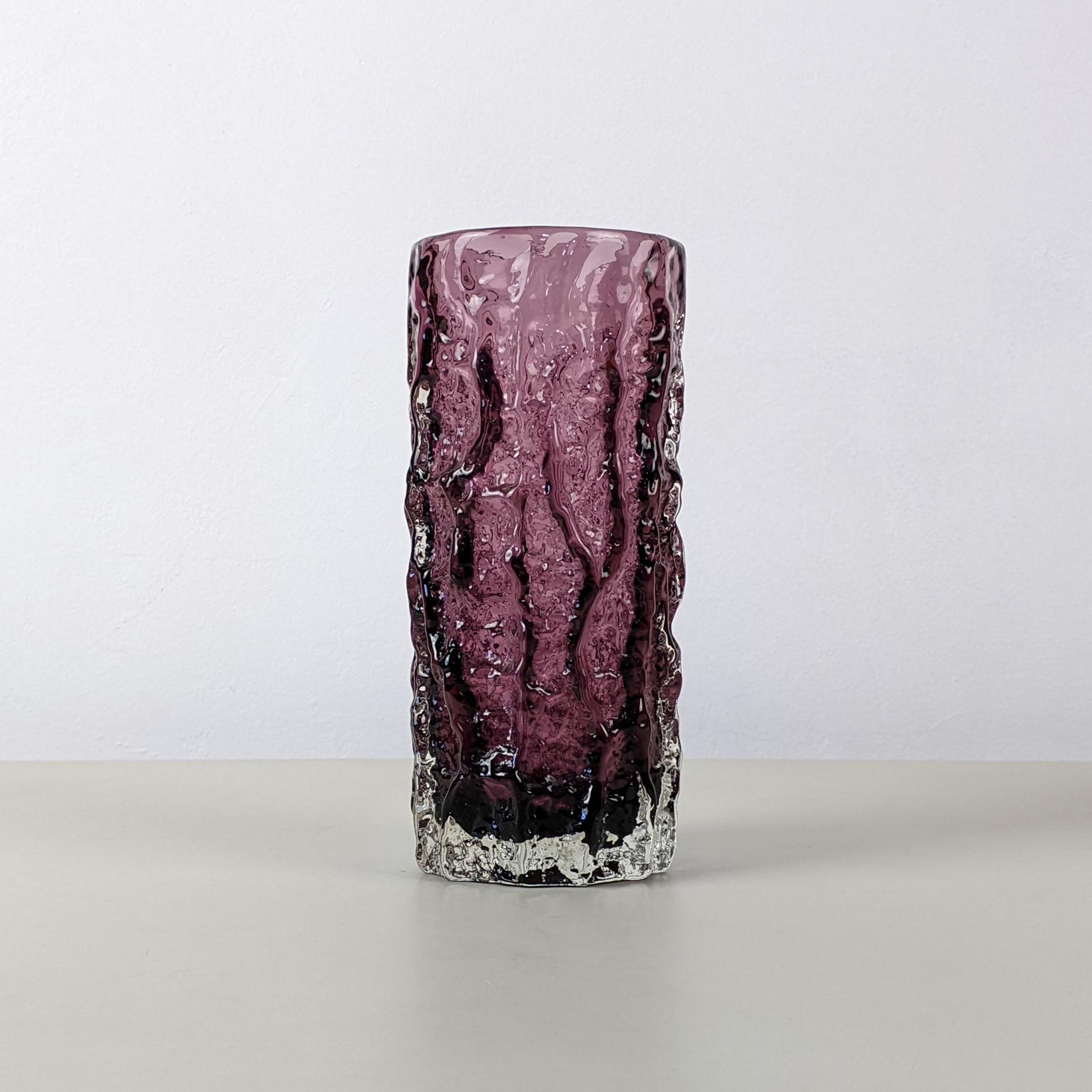 Geoffrey Baxter for Whitefriars, c. 1960s
Medium ‘Bark’ vase, from the “Textured’ range, model number 9690
Purple tinted glass
Excellent condition without damage

(We have various Bark vases available. This one is pictured alongside two orange