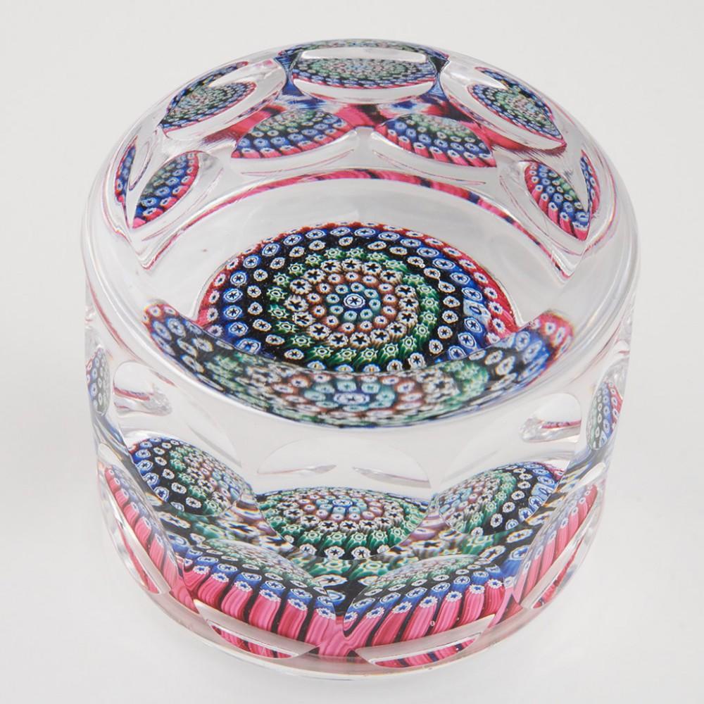 Heading : A Whitefriars Millefiori Cylinder Paperweight 1971
Date : 1971
Origin : United Kingdom
Features : Seven row millefiori concentric centre within a cylinder paperweight with multiple facets to the top and sides
Marks : A Whitefriars Monk