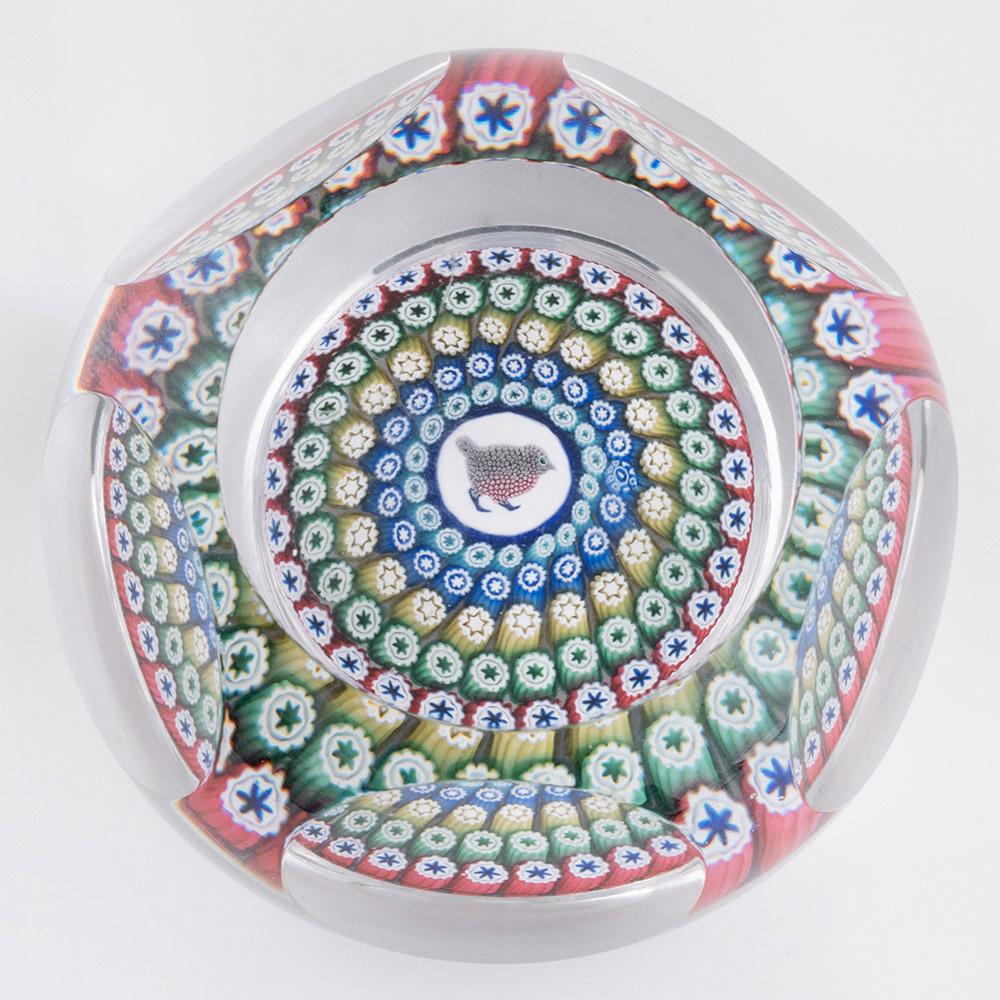 Heading : Whitefriars Paperweight Millefiori Robin 1974
Date : 1974
Origin : Scotland
Features : Five concentric millefiori rings with a central complex millefiori Robin cane
Marks : Whitefriars 1974 monk date cane
Type : Lead
Size : 8cm diameter,