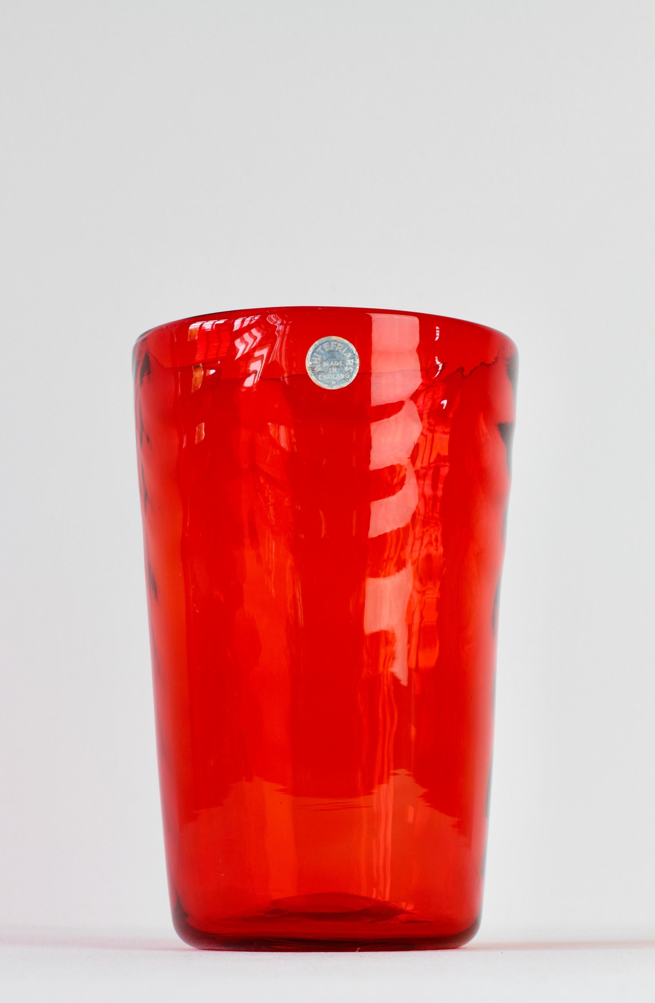Wonderful Mid-Century Modern vase by Barnaby Marriott Powell for British / English glass manufacturer Whitefriars glass, circa 1938. This beautiful bright ruby red wave ribbed vase with a classic funnel form captured in vivid, vibrant red coloured /