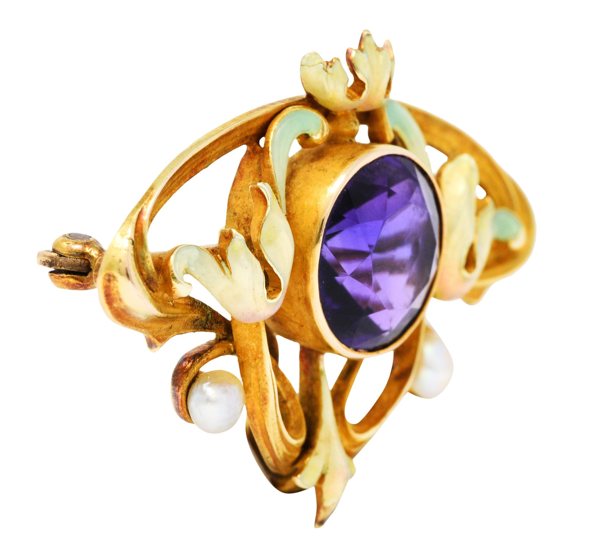 Brooch is designed as scrolling whiplash with elegant foliate forms

Centering a 10.0 mm round cut amethyst, bezel set, and deeply purple in color

Glossed with translucent pastel green enamel - exhibiting some loss - consistent with age

Accented