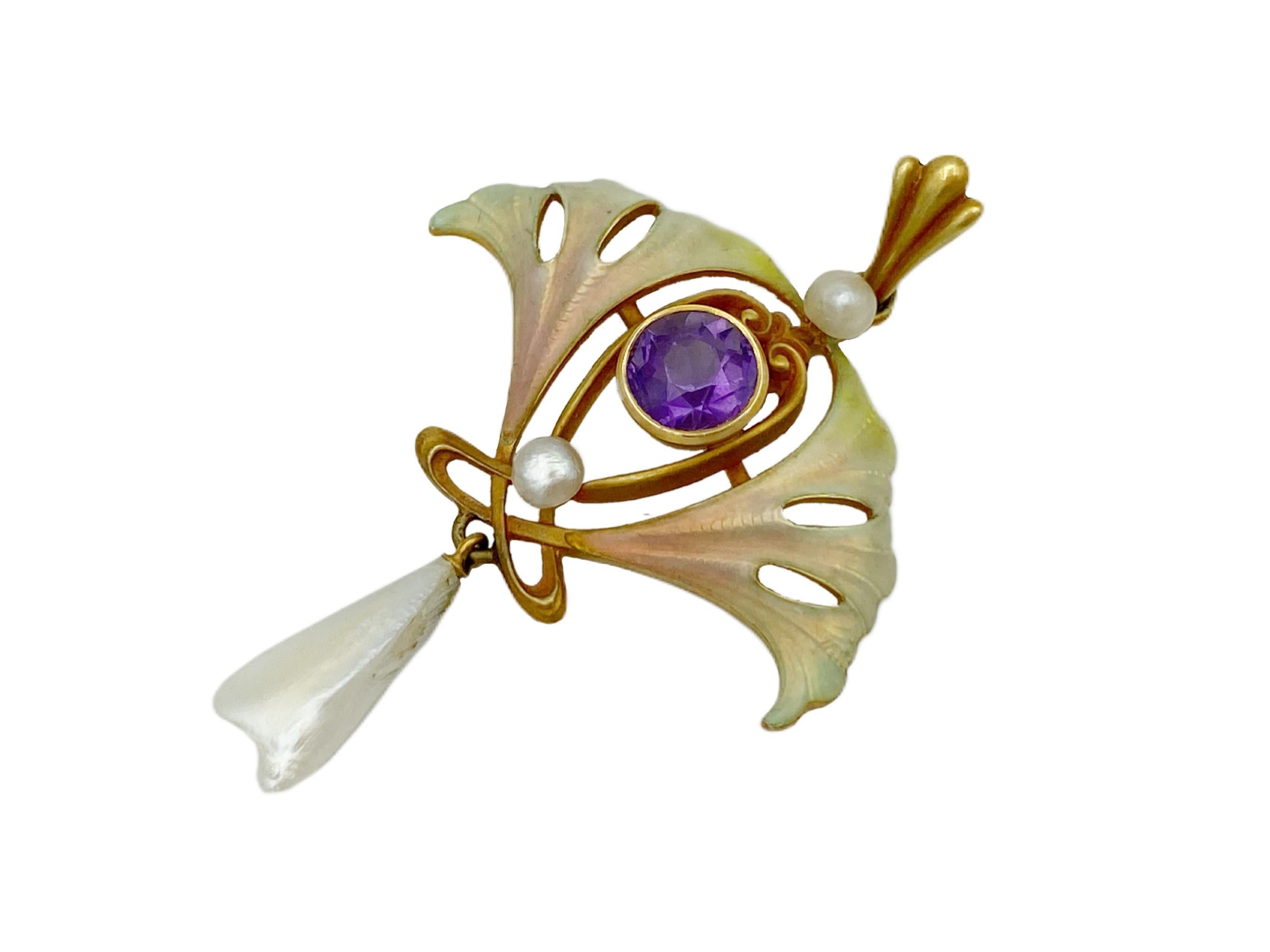 An extremely fine example of Art Nouveau period jewelry, this exquisite pendant is a timeless treasure of the highest quality. Crafted from 14k yellow gold, accented with amethyst and natural pearls, it is adorned with an intricately detailed gingko