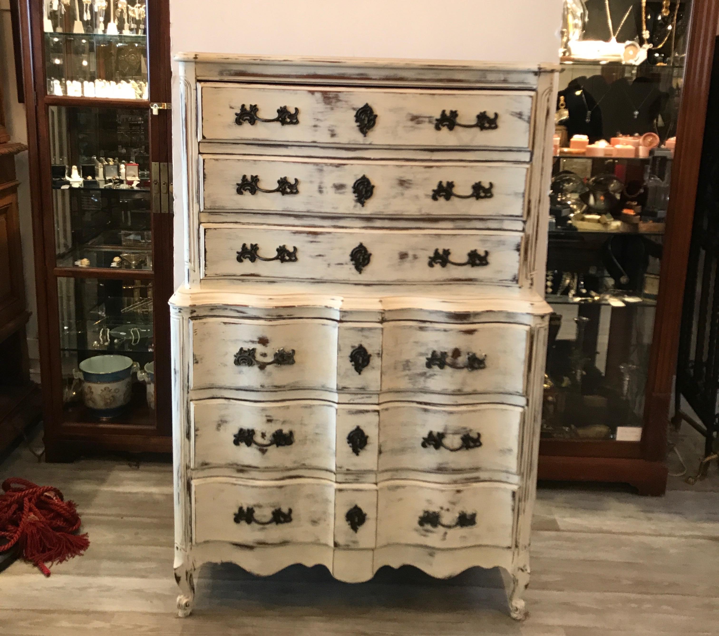 Solid walnut chest on chest with a whitewashed and distressed finish. Three smaller drawers above three larger drawers. The chest with a scalloped front, solid side panels and a larger stepped out base of drawers.