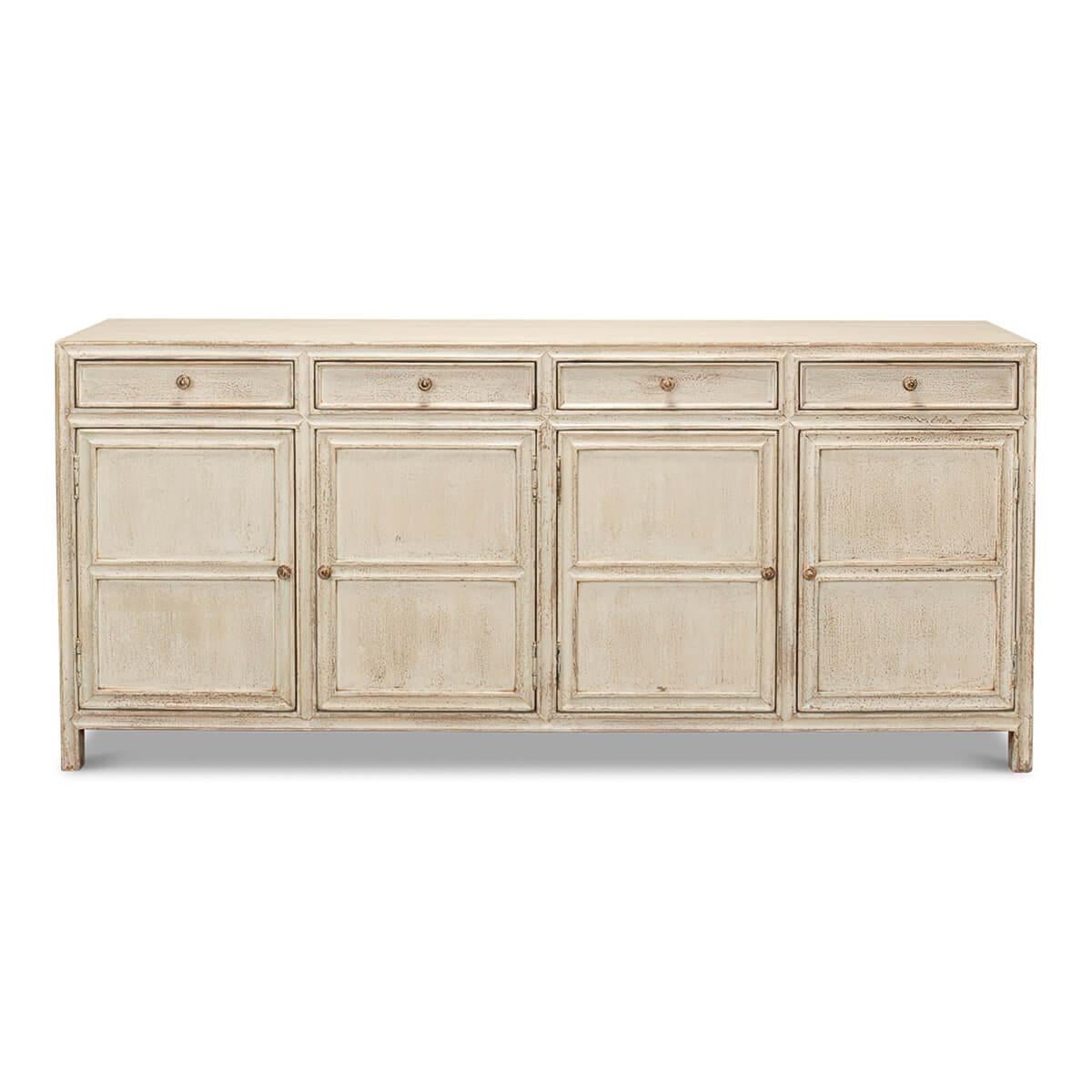 A modern whitewash painted sideboard with panel molding. This piece has four doors detailed with molding and four drawers with distressed metal hardware. 

This sideboard is crafted in pine with a distressed painted finish in eclectic white.