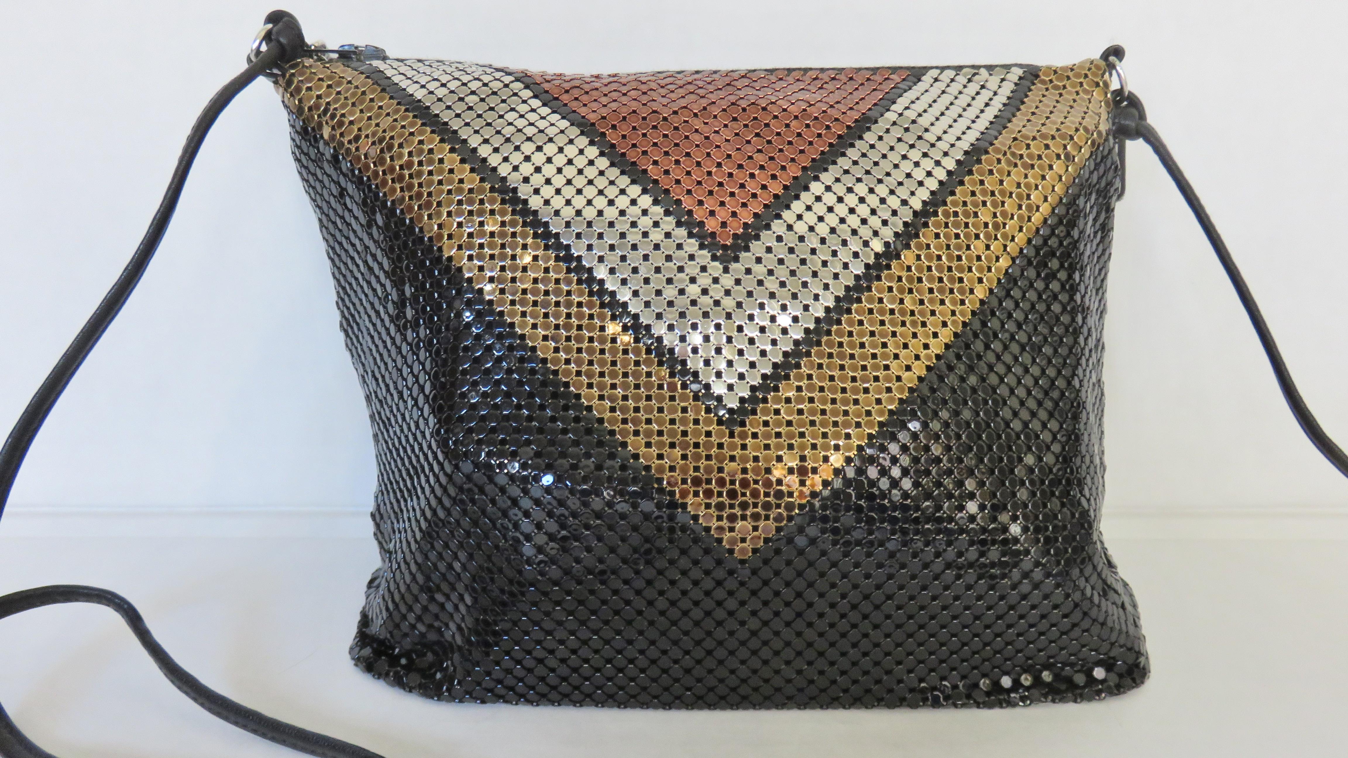 A fabulous Whiting and Davis color block metal mesh chain mail shoulder strap bag.  It is square with triangular inset of bronze silver and gold colored metal mesh on a black mesh background and solid black on the back.  There is a long fine black