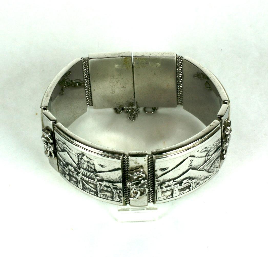 Unusual Whiting and Davis Japonesque Panel Bracelet in silverplate panels backed on their signature mesh. Panels depict temples and mountain ranges with applied dragon motifs on clasp and mid links.
1950's USA.  Excellent condition. Signed.
7