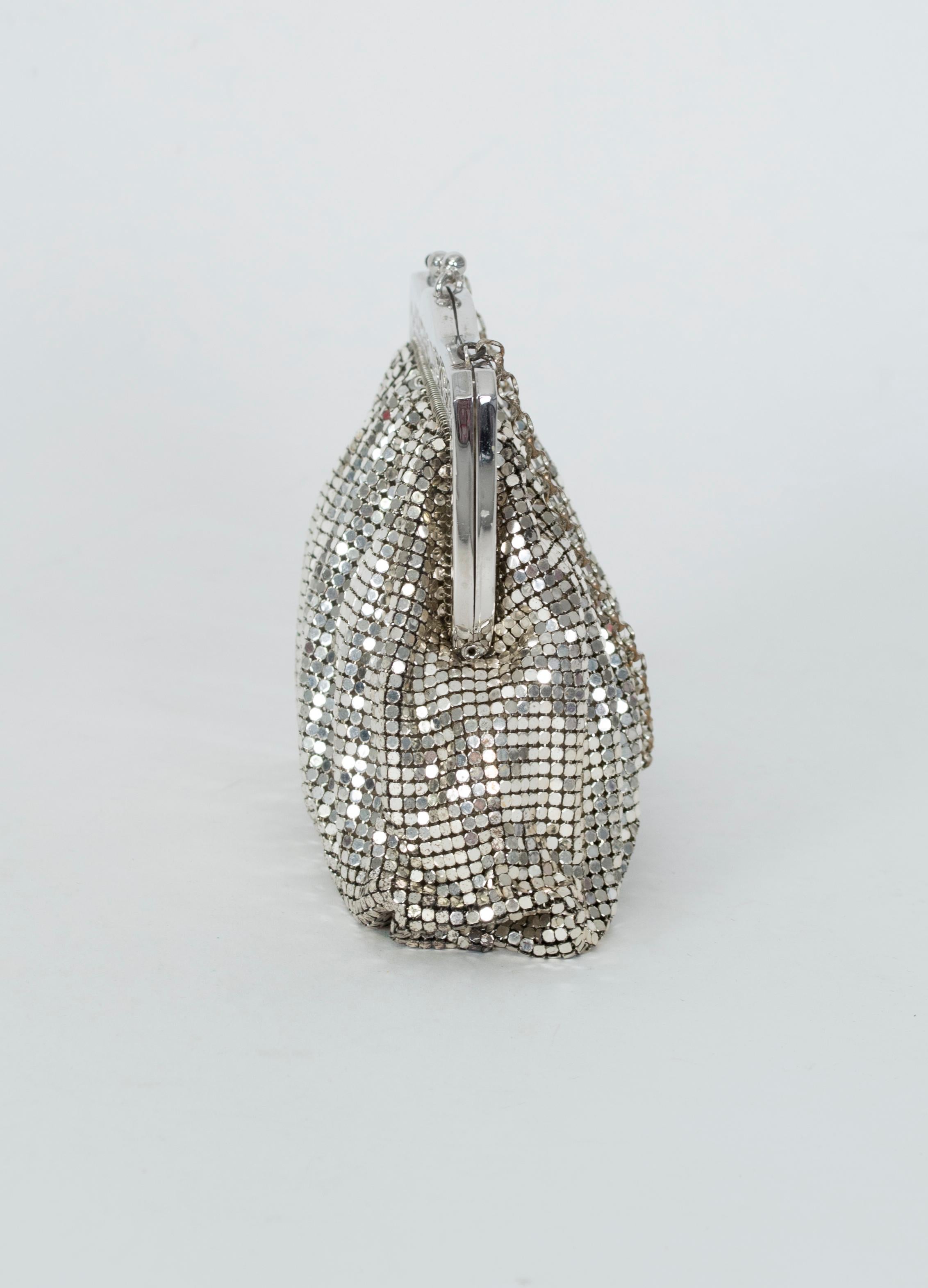 An evening bag that bridges decades, this liquid silver mesh purse looks equally appropriate with a mid-century sheath as it does with a slithery disco halter dress. In scarce and sparkling silver as opposed to the more abundant gold models, it
