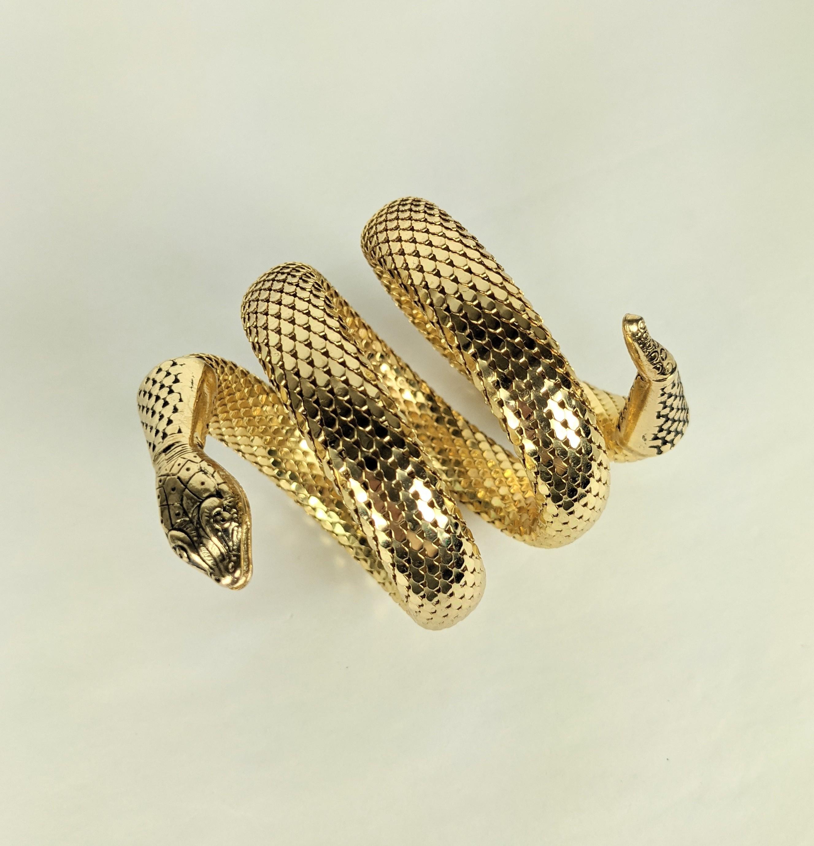 Whiting Davis Coiled Snake Bracelet from the 1980's. Signature mesh is used to form the coiled scales on the snakes body with detailed gilt head and tail. 1980s USA.
Approx 3