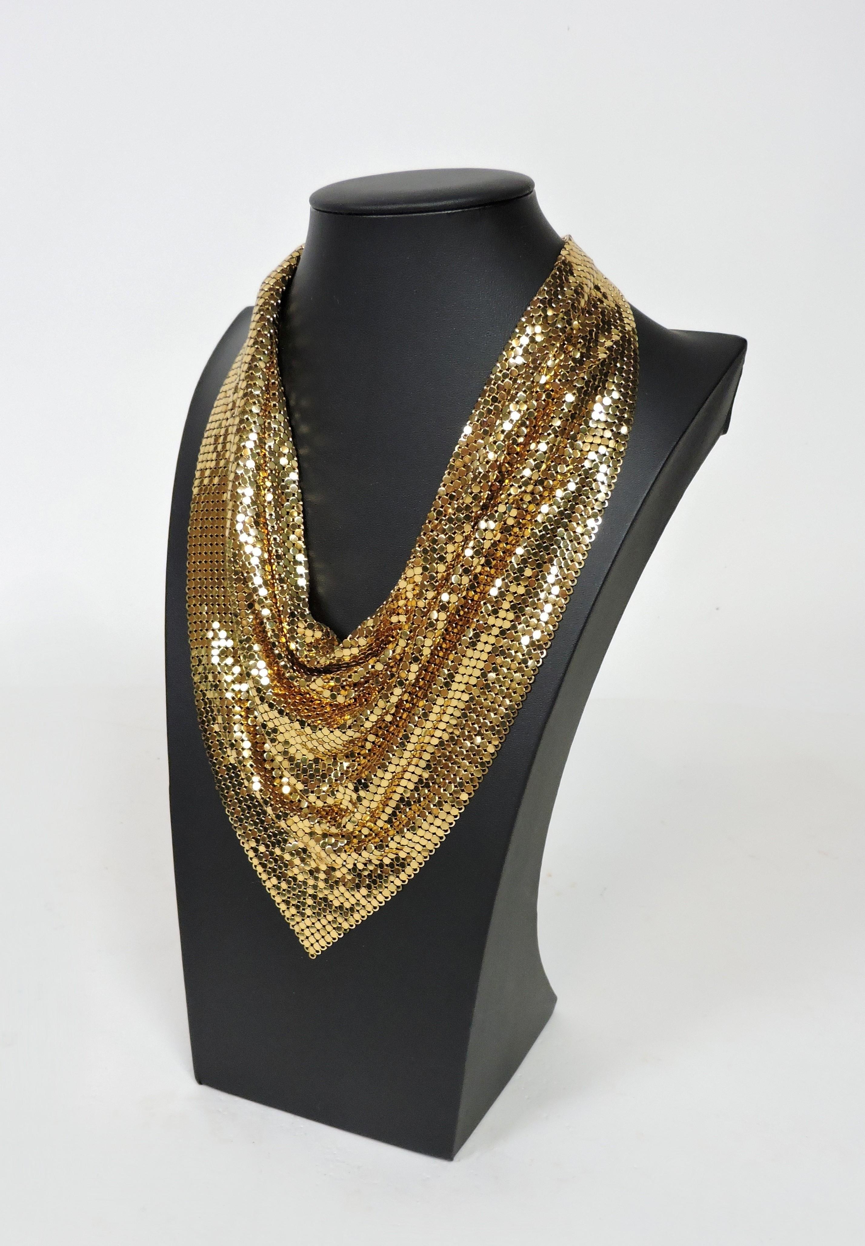 Glamorous gold tone mesh necklace manufactured by Whiting and Davis Co. This high quality necklace drapes beautifully and has an approximately 10 inch drop as pictured on the mannequin. Somewhat adjustable with a hook and chain closure on the back.