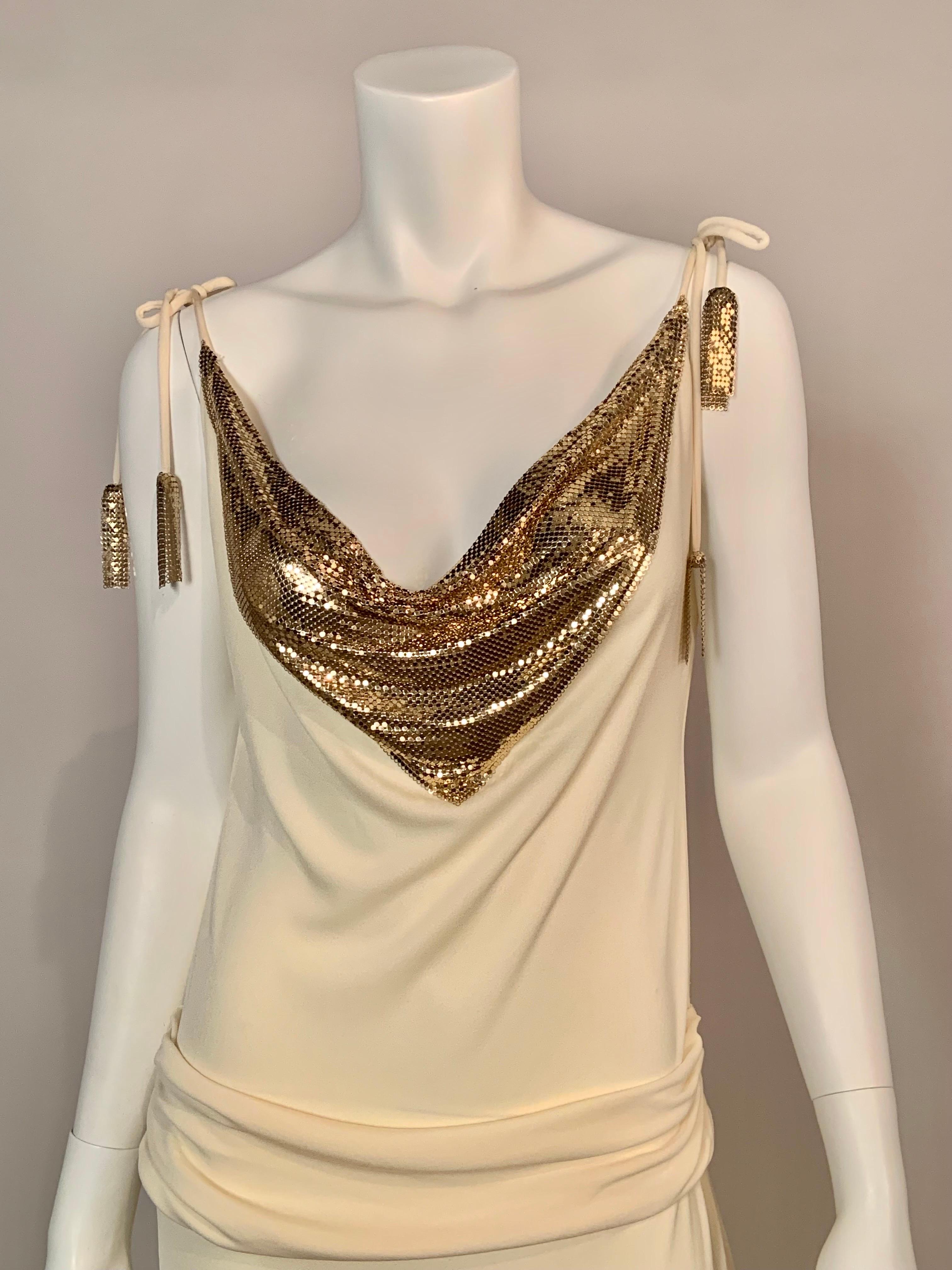 A glamourous cream jersey evening dress from the late 1980's is embellished with Whiting & Davis gold toned metal mesh at the neckline, both front and back.  The shoulder straps tie so you can adjust the fit. They are finished with Whiting & Davis