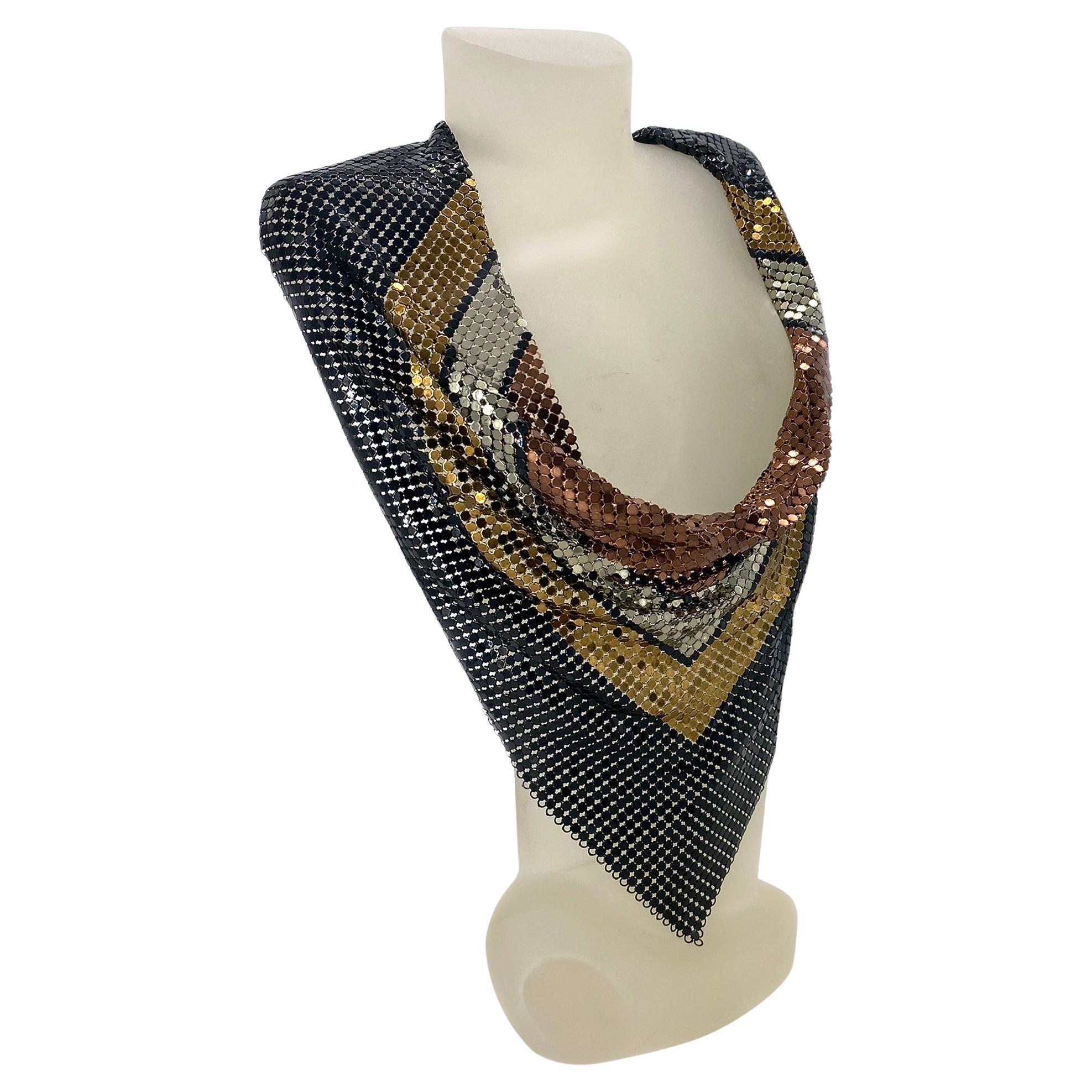 This is a multi-color metal chainmail scarf necklace. It featuring a unique design that incorporates black, gold silver and copper tones. This 18 inch width scarf necklace has a hook clasp with 2 inch extension chain/tail with Whiting & Davis tag