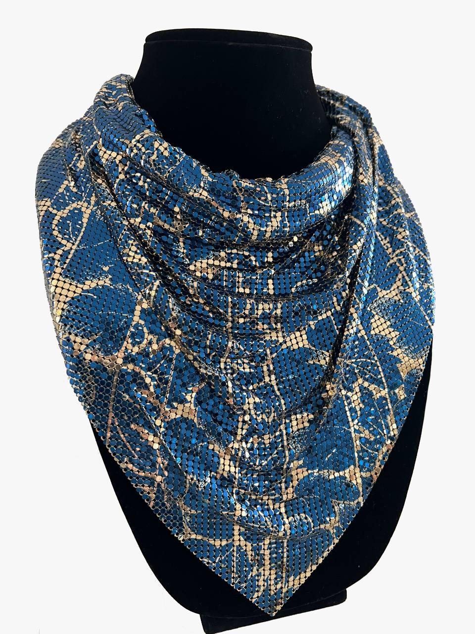 Whiting Davis rare mesh bib necklace

A wonderful blue and gold mesh bib necklace that when worn resembles an elegantly styled scarf around the neck.

The necklace fastens by a simple hook that connects to a series of chain links on the opposite