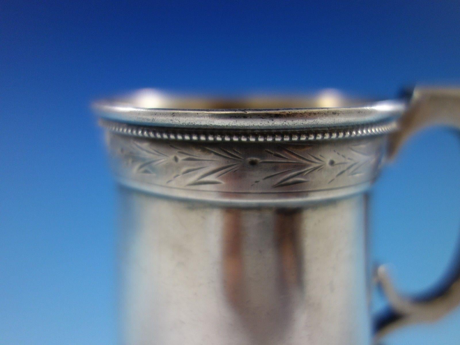 Whiting sterling silver Child's Cup featuring a brite-cut upper and lower border with beading above the brite-cut design on the upper border. This is piece is marked #35. The measurement for this piece is 3 1/4 x 2 1/2, and it weighs 3.8 ozt. It is