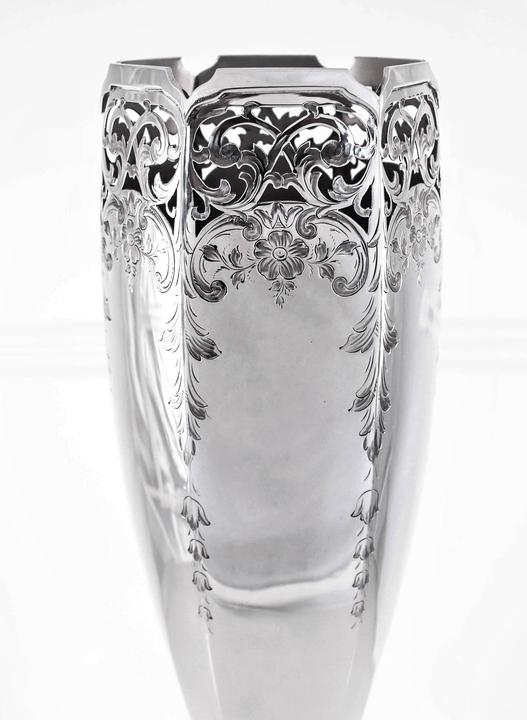 This vase is as pretty as it gets! Notice the shape of the rim and how it deeps down at each corner, now look at the lovely lattice work at the top just beneath that etched flowers and garlands drape down the sides. This piece has six sides and a