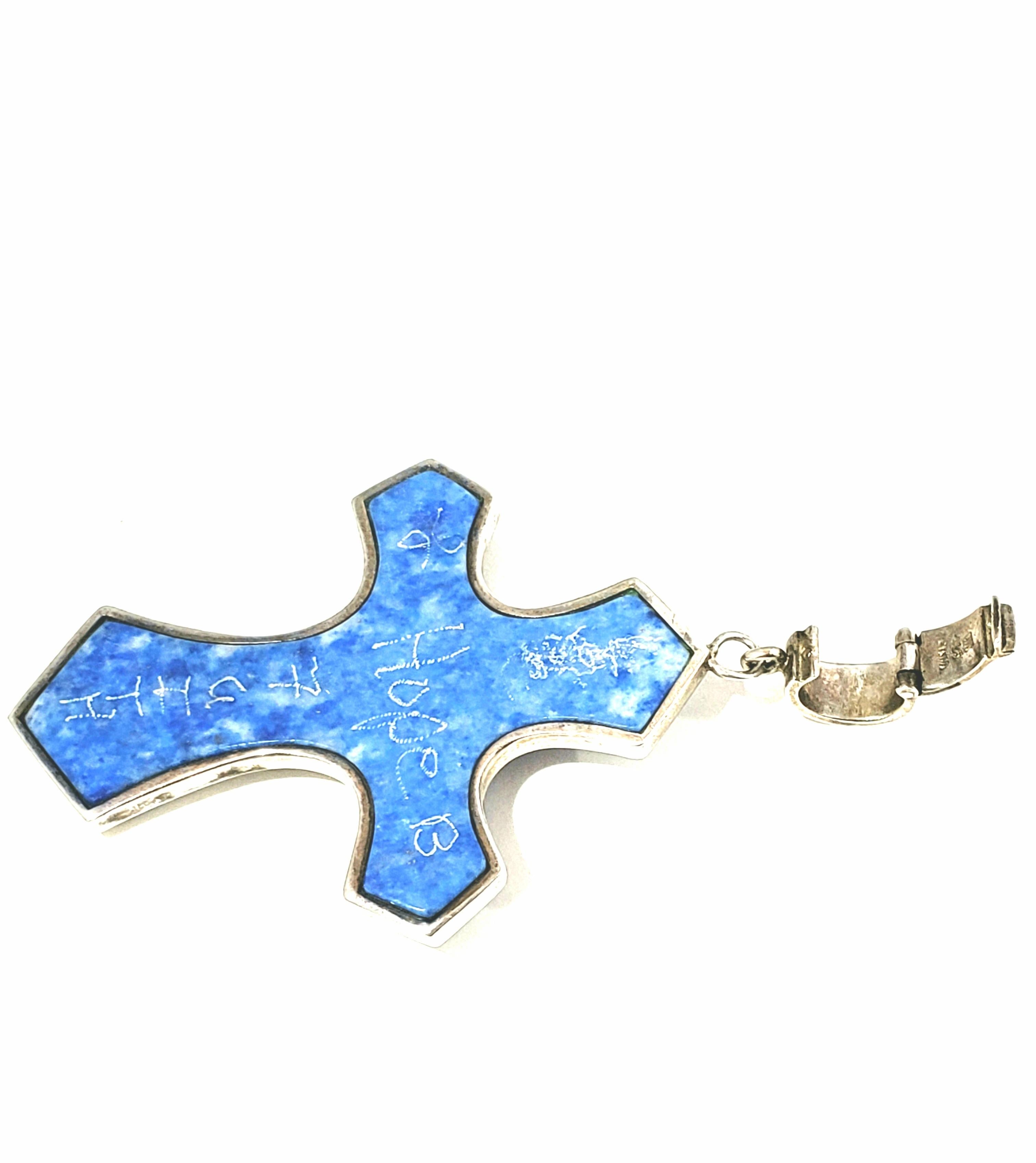 Whitney Kelly WK Sterling Blue Denim Lapis Cross Pendant

This is a large denim lapis stone cross pendant by Whitney Kelly WK.  It is double sided and framed in sterling silver & decorated with beads on one side. The bail has a hinged enhancer that