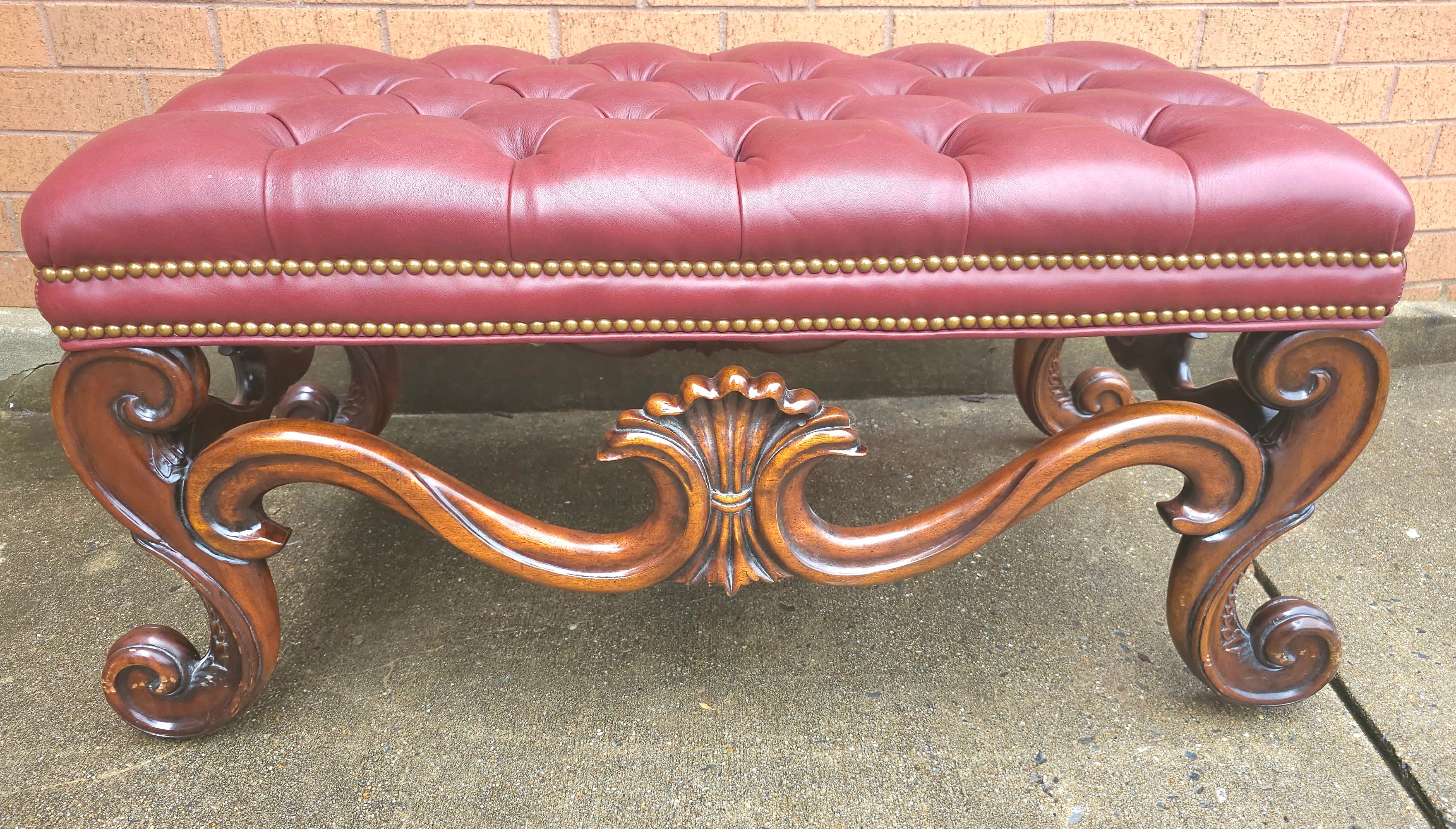 A Whittemore-Cherrill Mahogany Brass Nail Trims and tufted Maroon Top Grain Leather Upholstered Bench / Ottoman in great condition. Measures 37