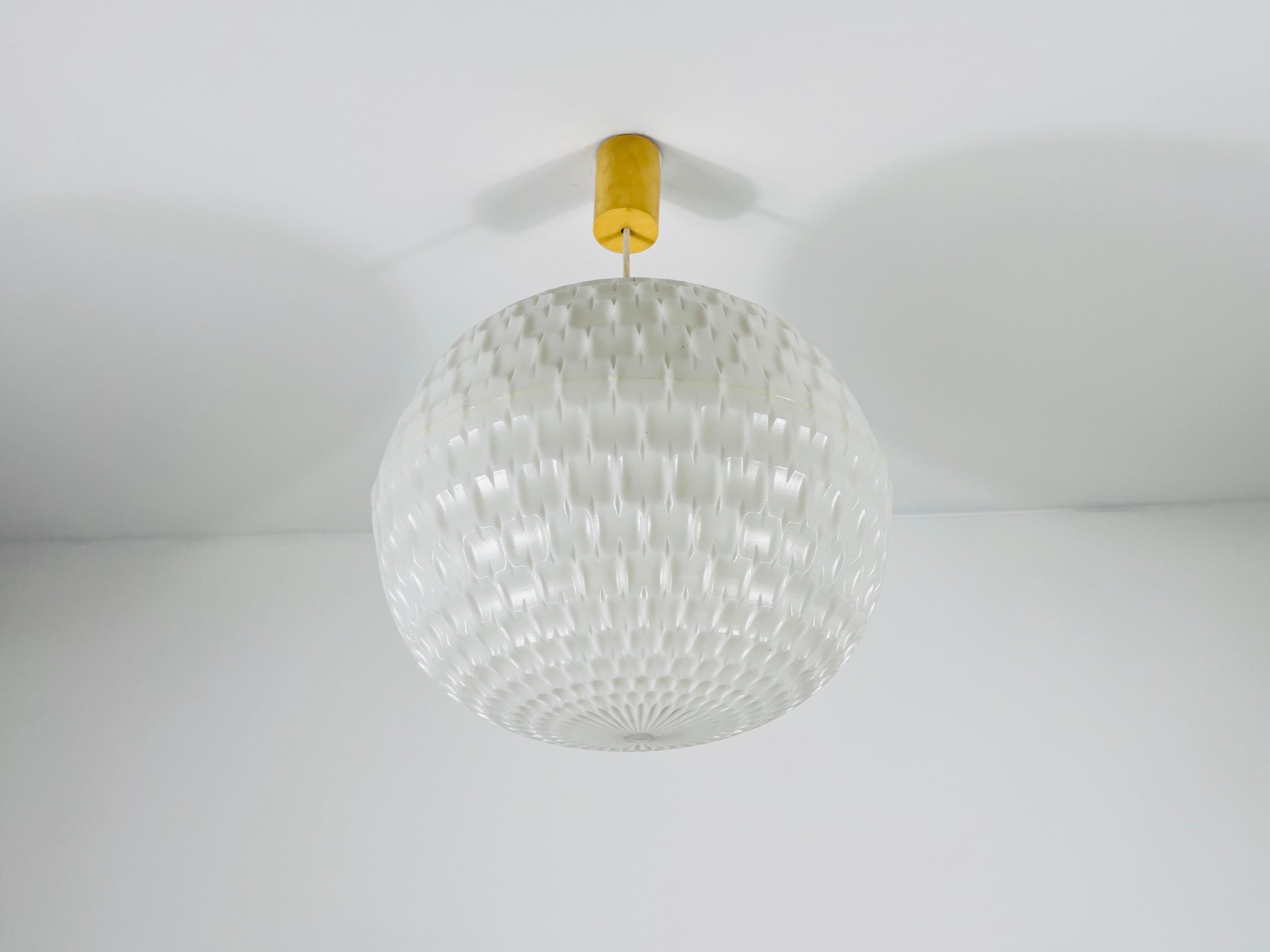 Peill & Putzler pendant lamp, designed by Aloys Gangkofner in 1970. This elegant white lamp features a minimalist design that perfectly embodies mid-century modern aesthetics. Its soft, warm light creates a cozy and inviting atmosphere, making it an