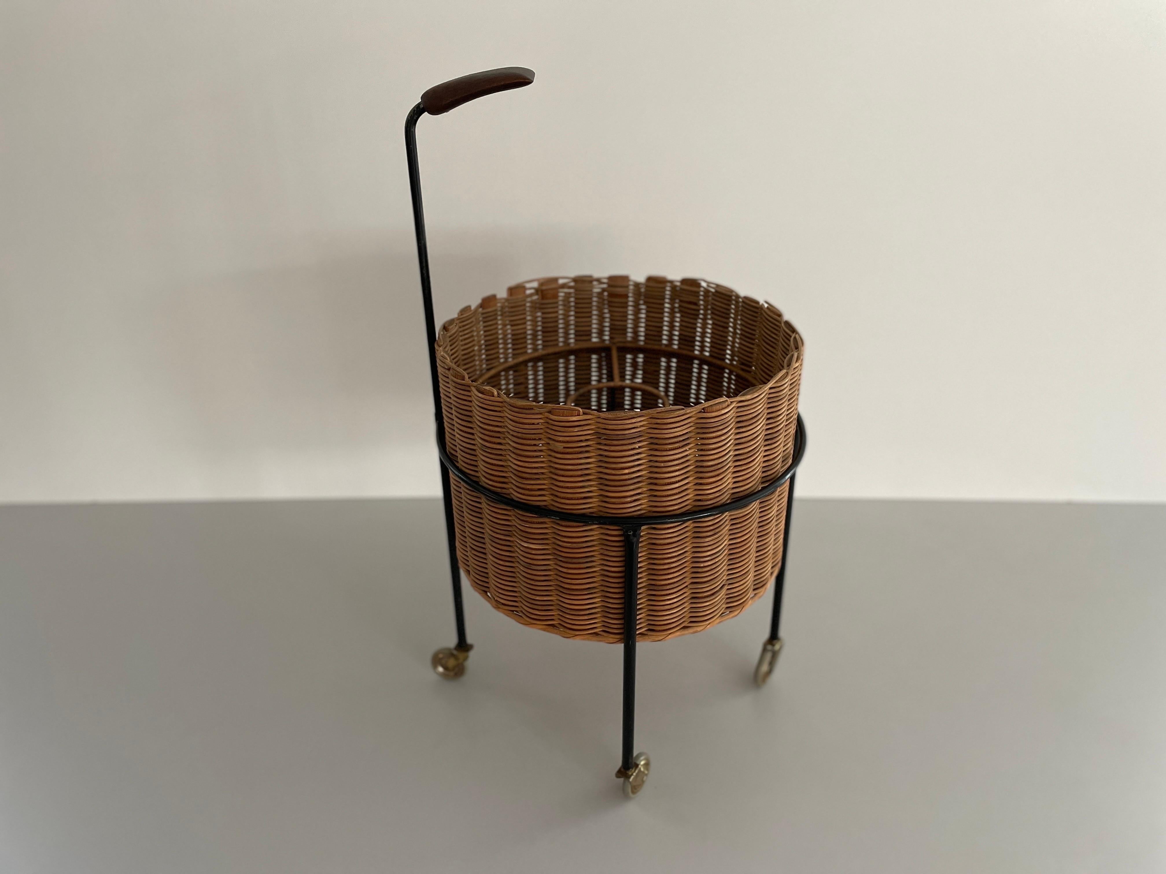 Wicker and Black Metal Serving Bar Cart Bottle Holder, with Teak Handle
1960s, Germany

It is very ideal and suitable for all living areas.

No damage, no crack.
Wear consistent with age and use.

Measurements: 
Height with handle: 72 cm
Height: 47